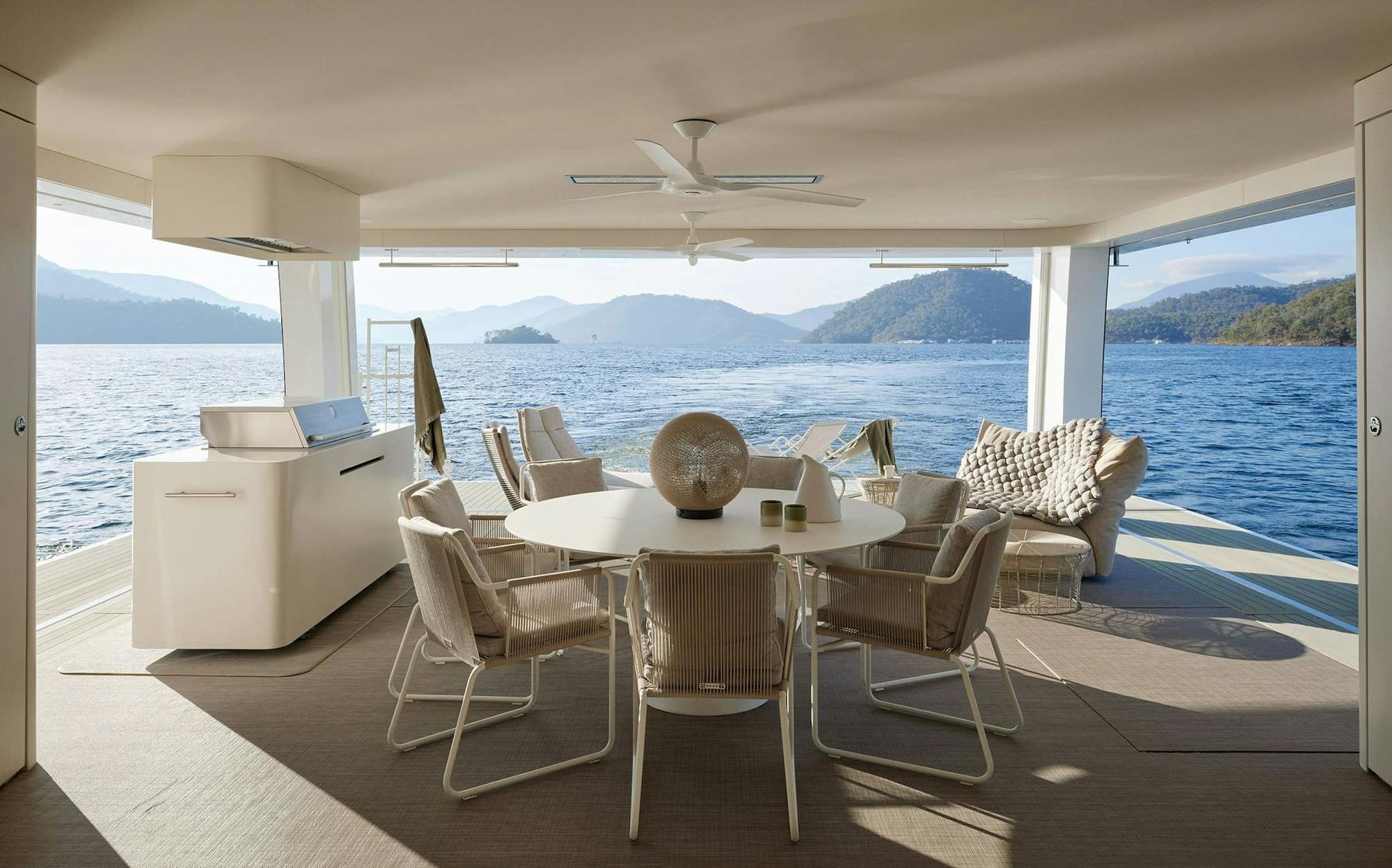 Halcyon by Jolson. View form yacht on water with outside dining area and bbq