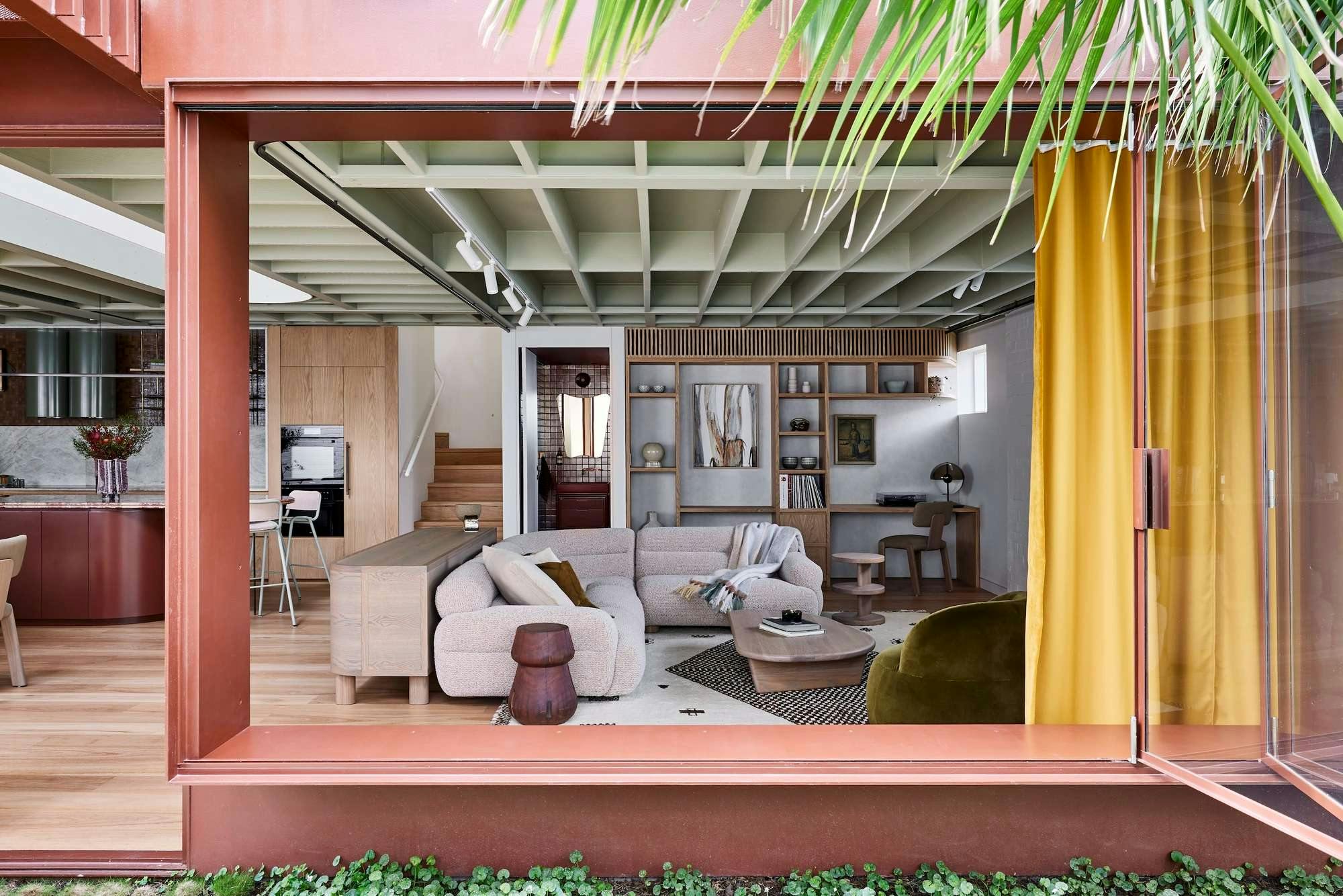 Rosso Verde House by Carter Williamson Architects. View to living room featuring mustard curtains and puffy sofa