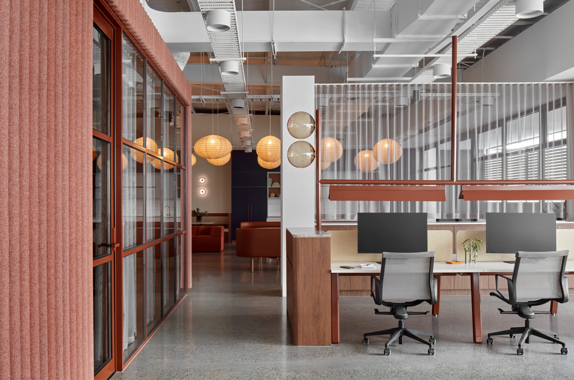 Beacon HQ by Foolscap Studio. Office space overview with rice paper lamps, customized light and desk installation. 