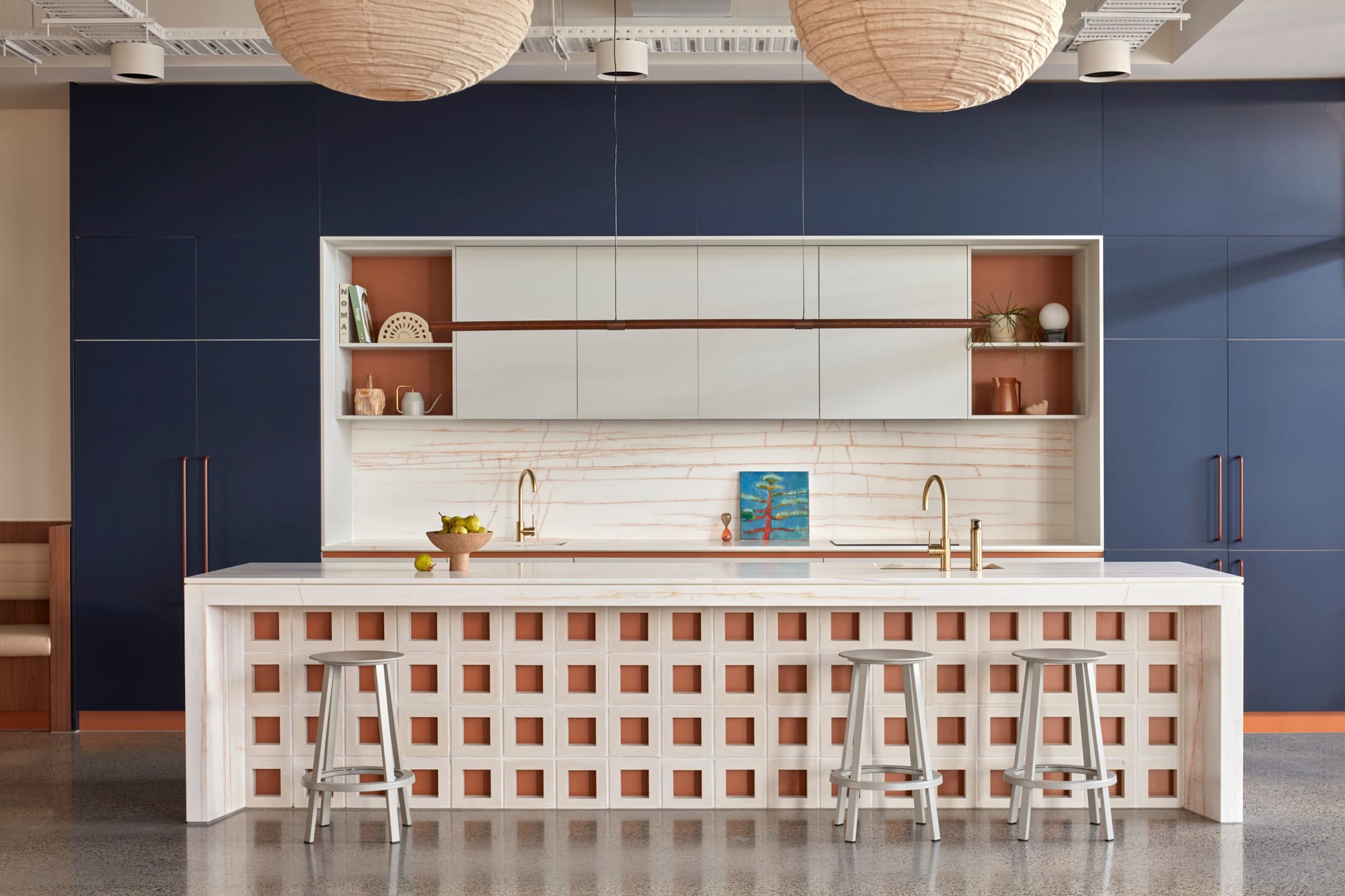 Beacon HQ by Foolscap Studio. Office kitchen overview featuring floor to ceiling, built in cabinet and white marble island.