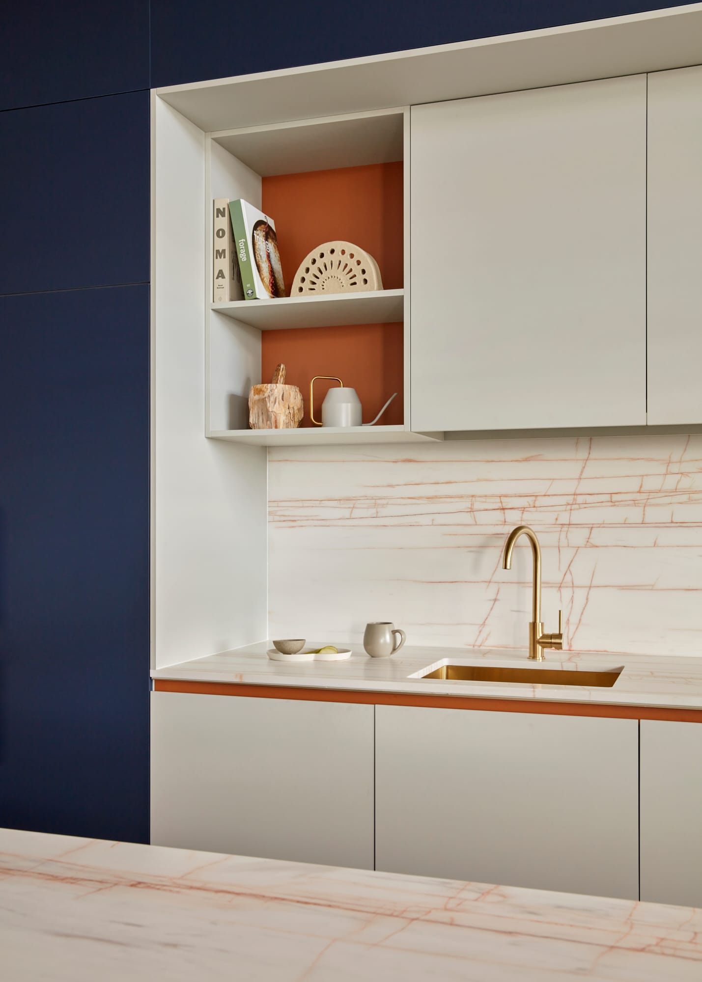 Beacon HQ by Foolscap Studio. Office kitchen with white marble work surface build in cabinet and golden sink and tap.