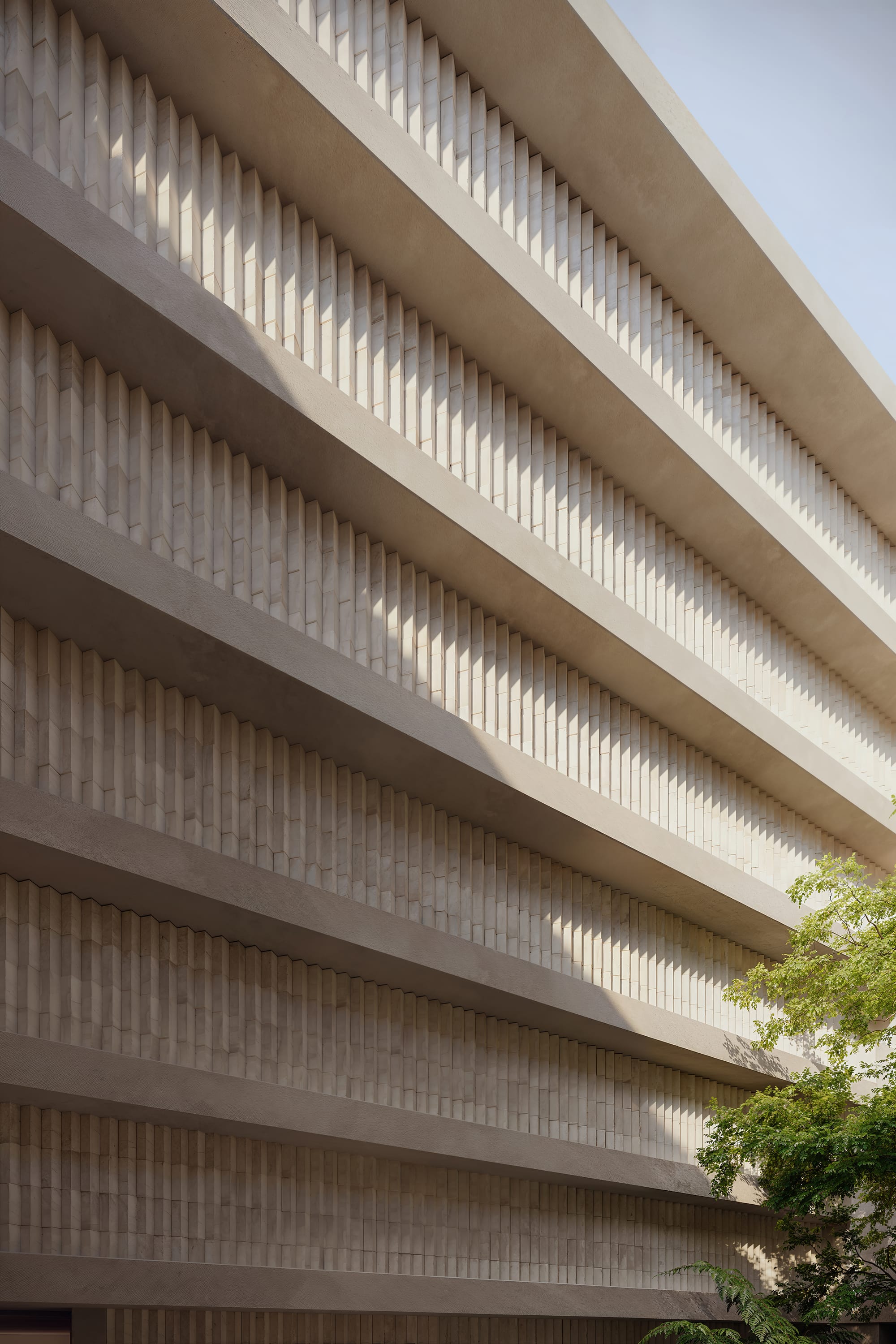 Fernhurst by ANGLE. Beige sandstone facade with angled arranged bricks.