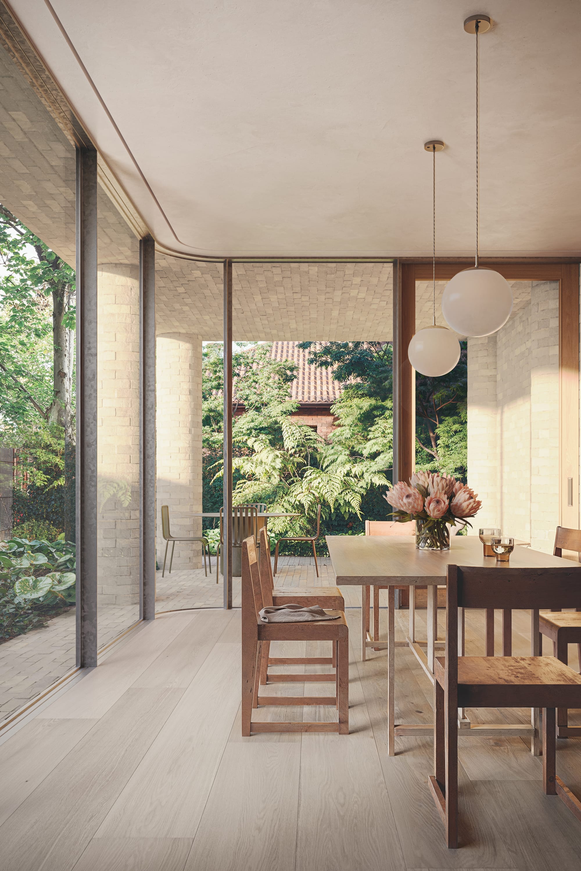 Fernhurst by ANGLE. Seating area featuring floor to ceiling windows and view to garden.