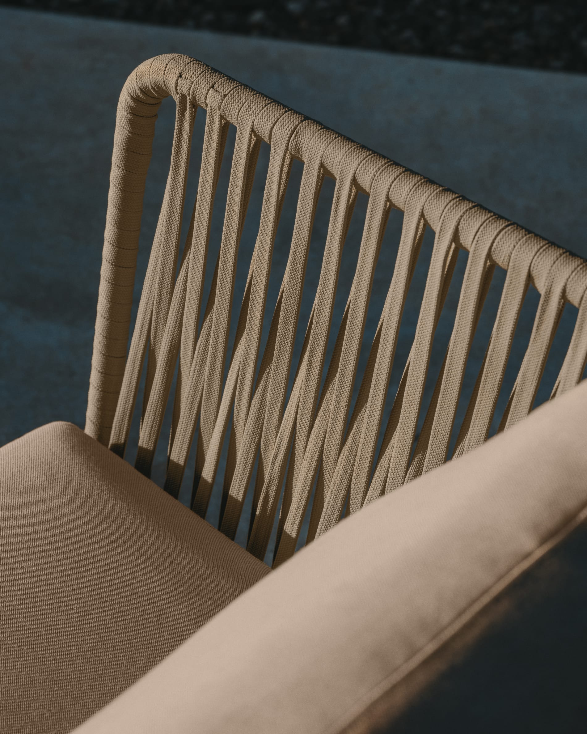 Kave Home. Detail shot of beige fabric outdoor lounge chair.