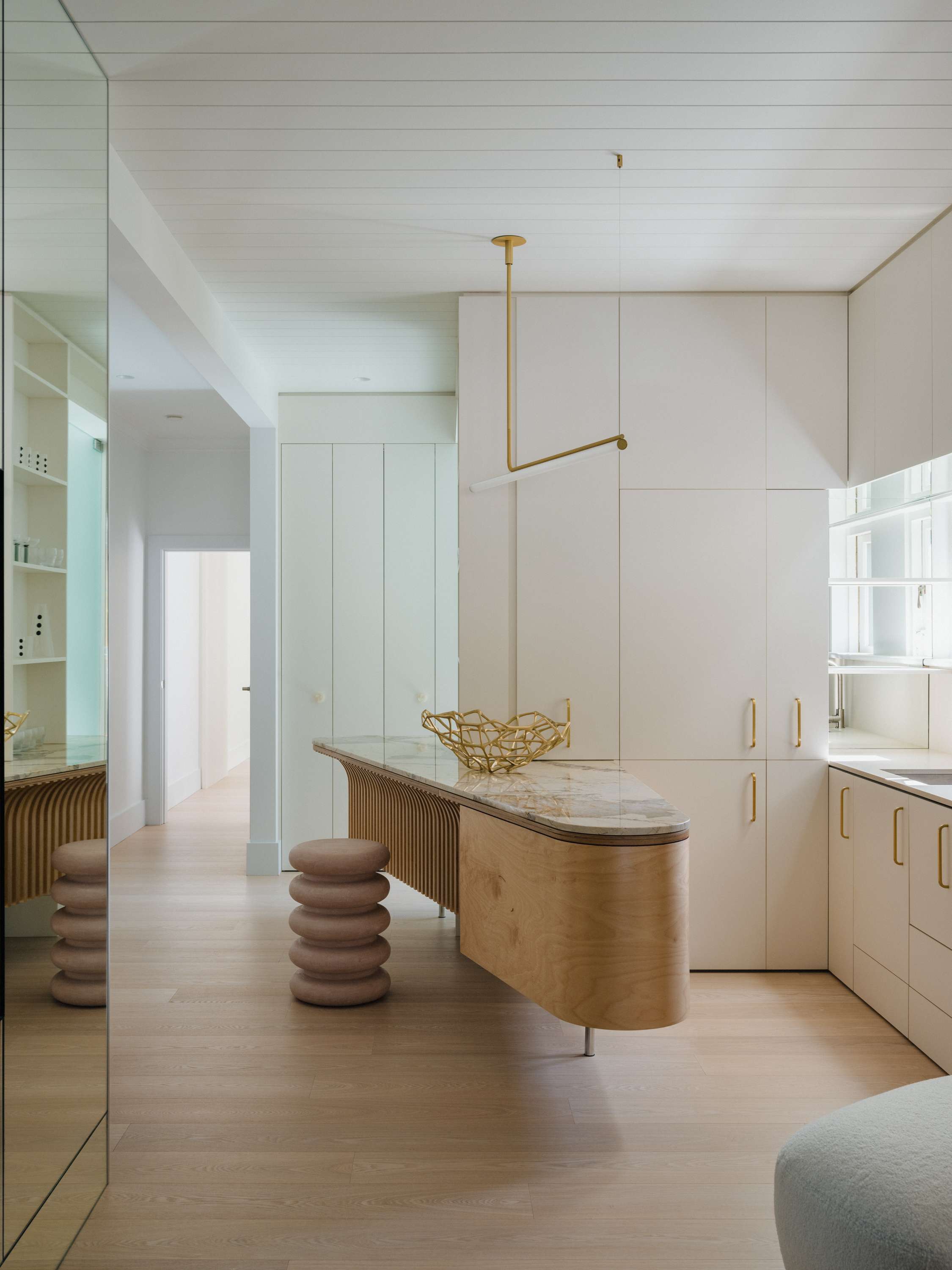 Kirribilli Downsize Apartment by Amandine & Simonetti Architecture. Customised kitchen island featuring bent plywood and marble work surface.