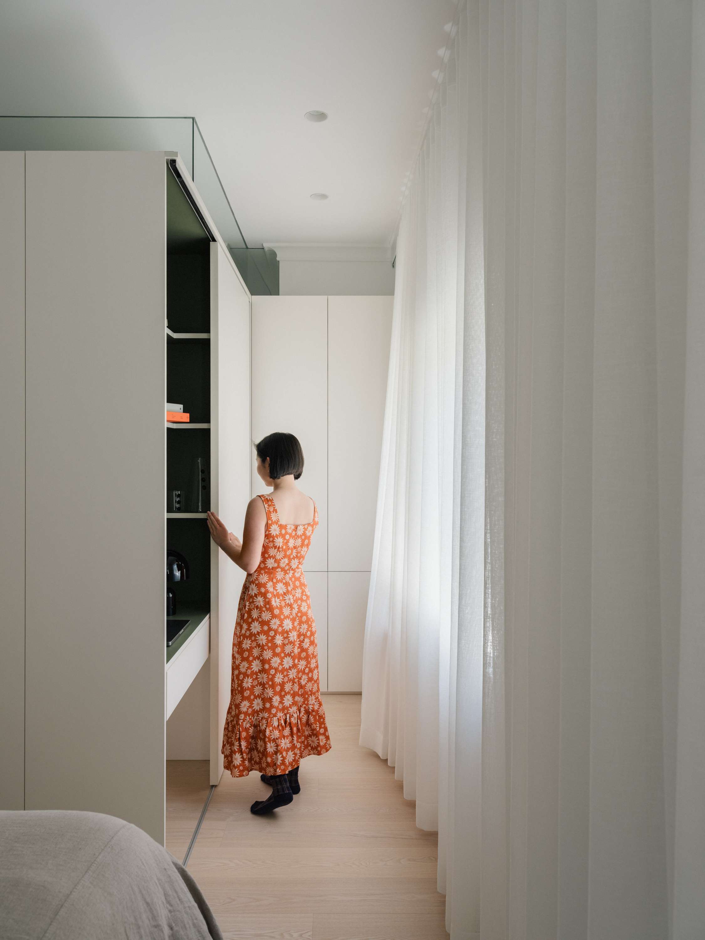 Kirribilli Downsize Apartment by Amandine & Simonetti Architecture. Bedroom with view on built-in cabinet.