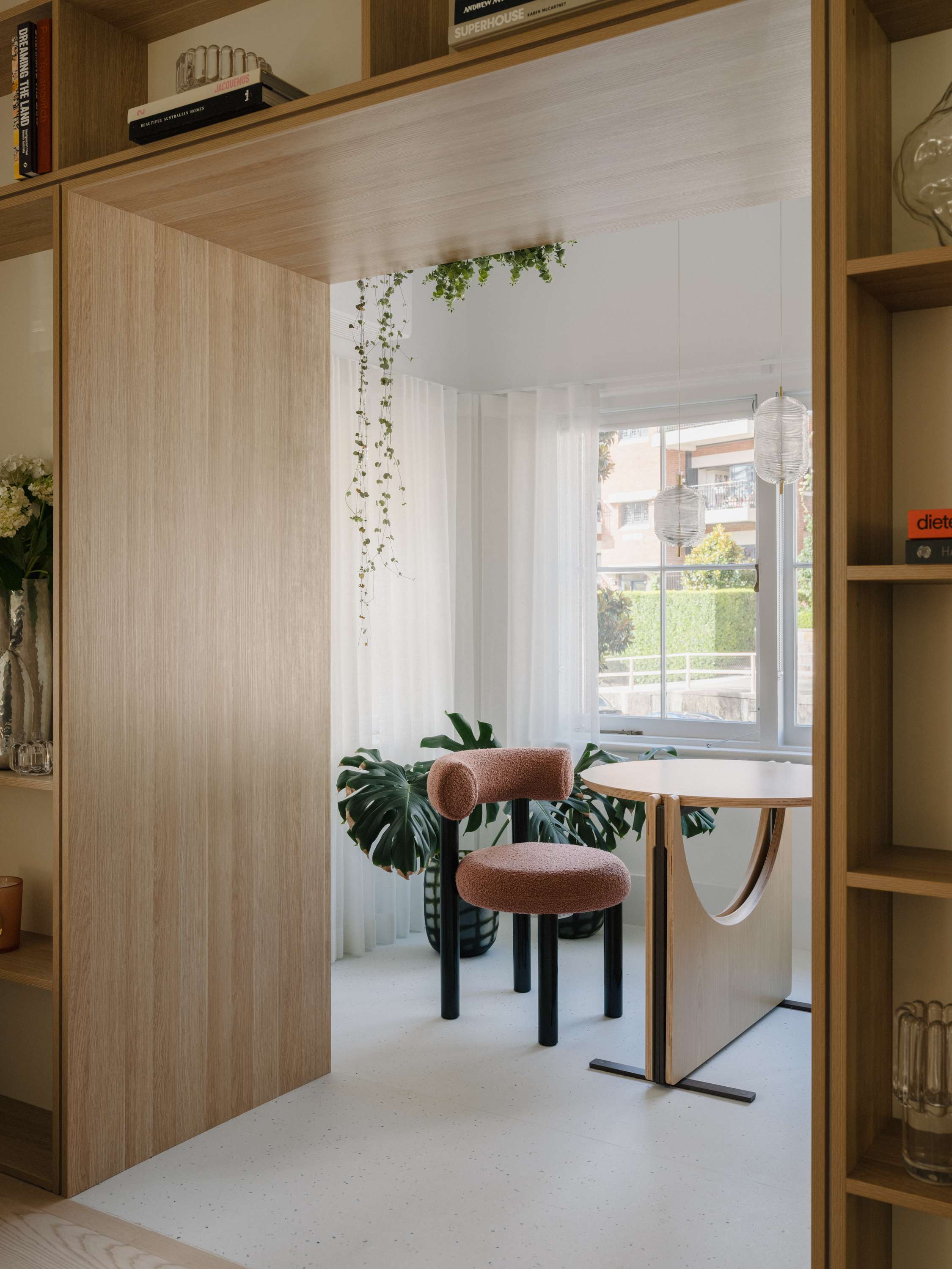 Kirribilli Downsize Apartment by Amandine & Simonetti Architecture. Dining room with 'fat dining chair' by Tom Dixon and folding table.