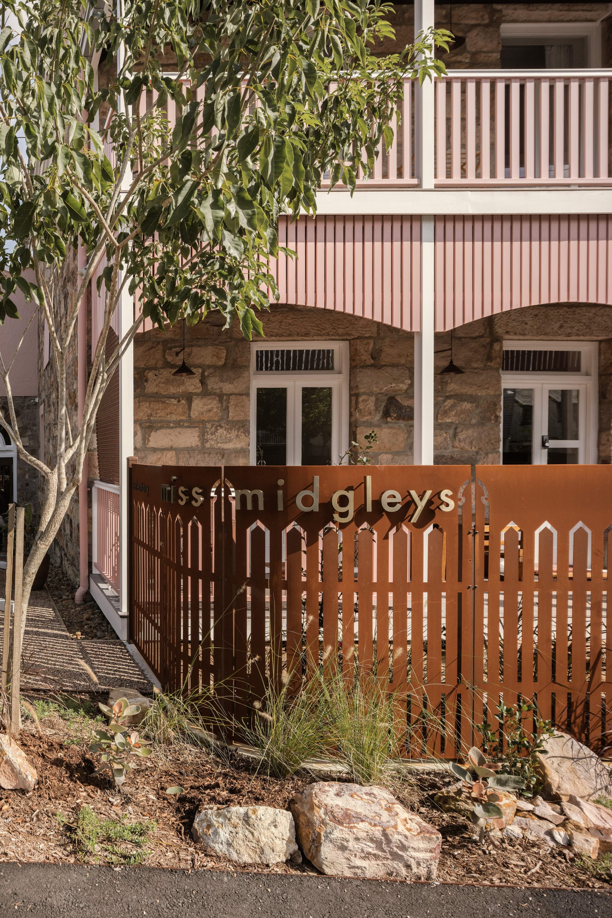 An exterior shot of Miss Midgelys showing the new corten fence at the front