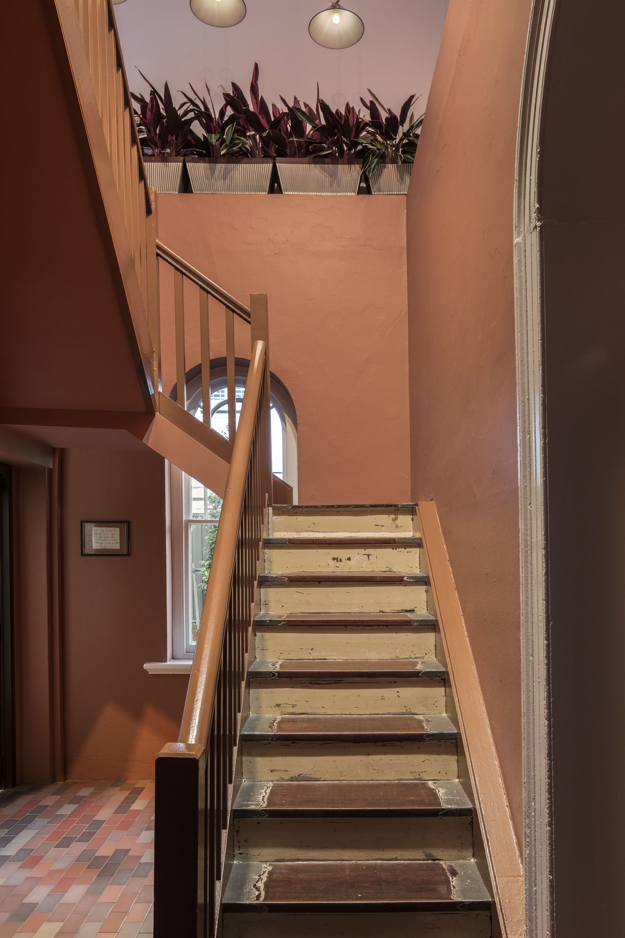 An interior shot of the renovated hotel showing the communal staircase