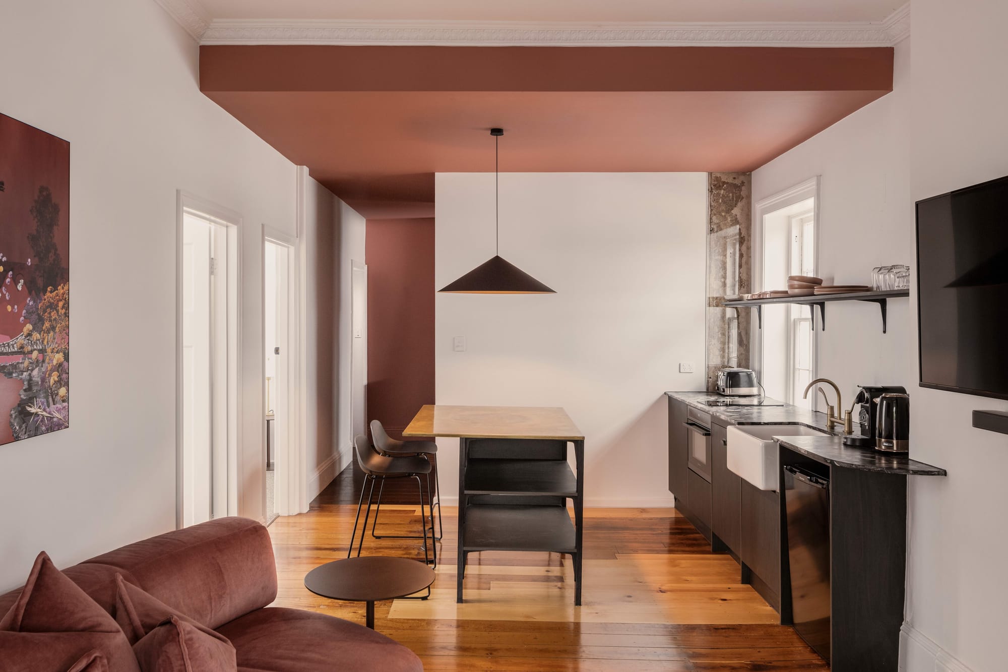 An interior shot of one of the boutique hotel rooms showing the kitchen and living spaces