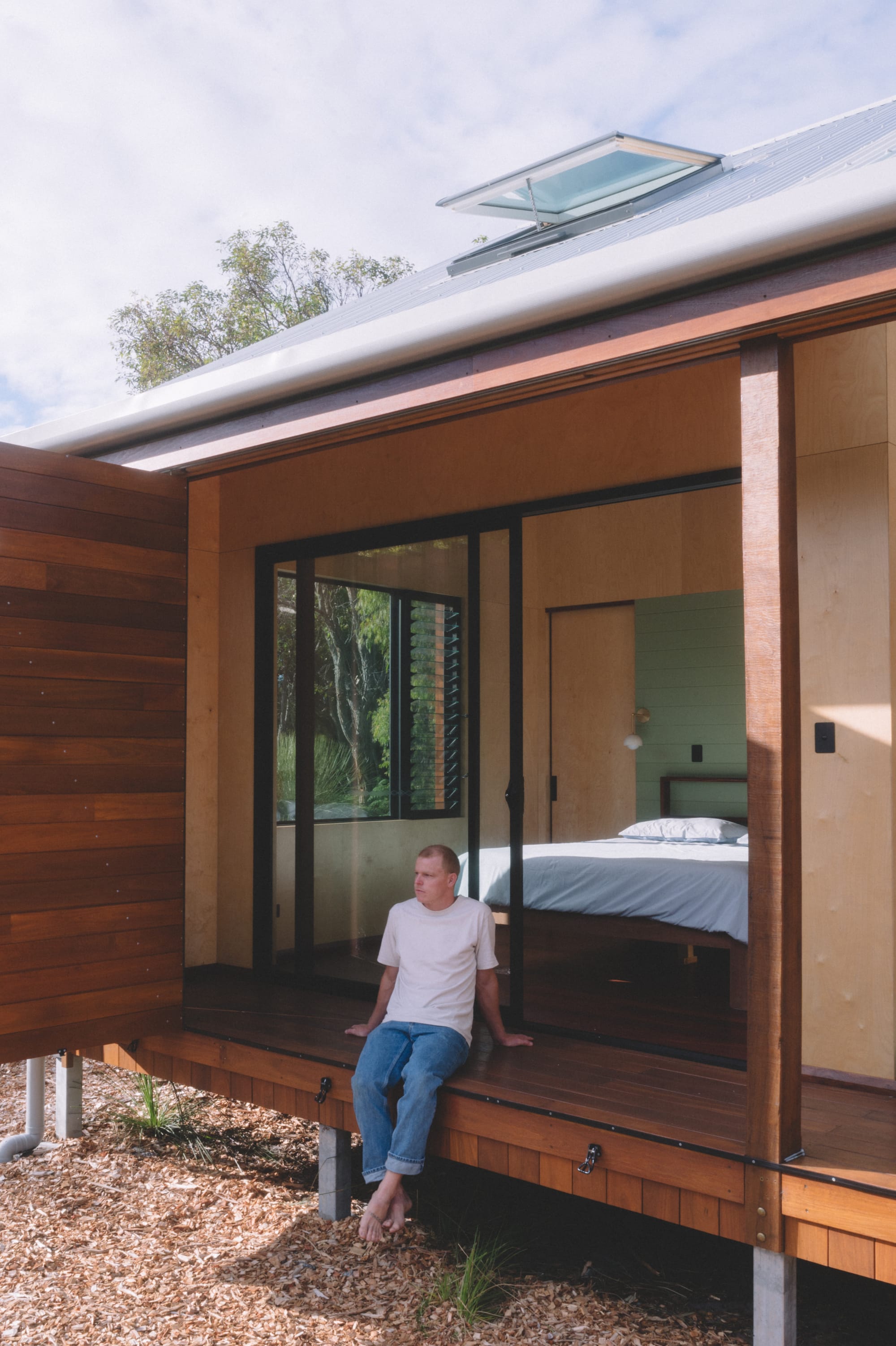 Nullaki House by Bare Architects. Minimalistic house on stilts and view to bedroom.