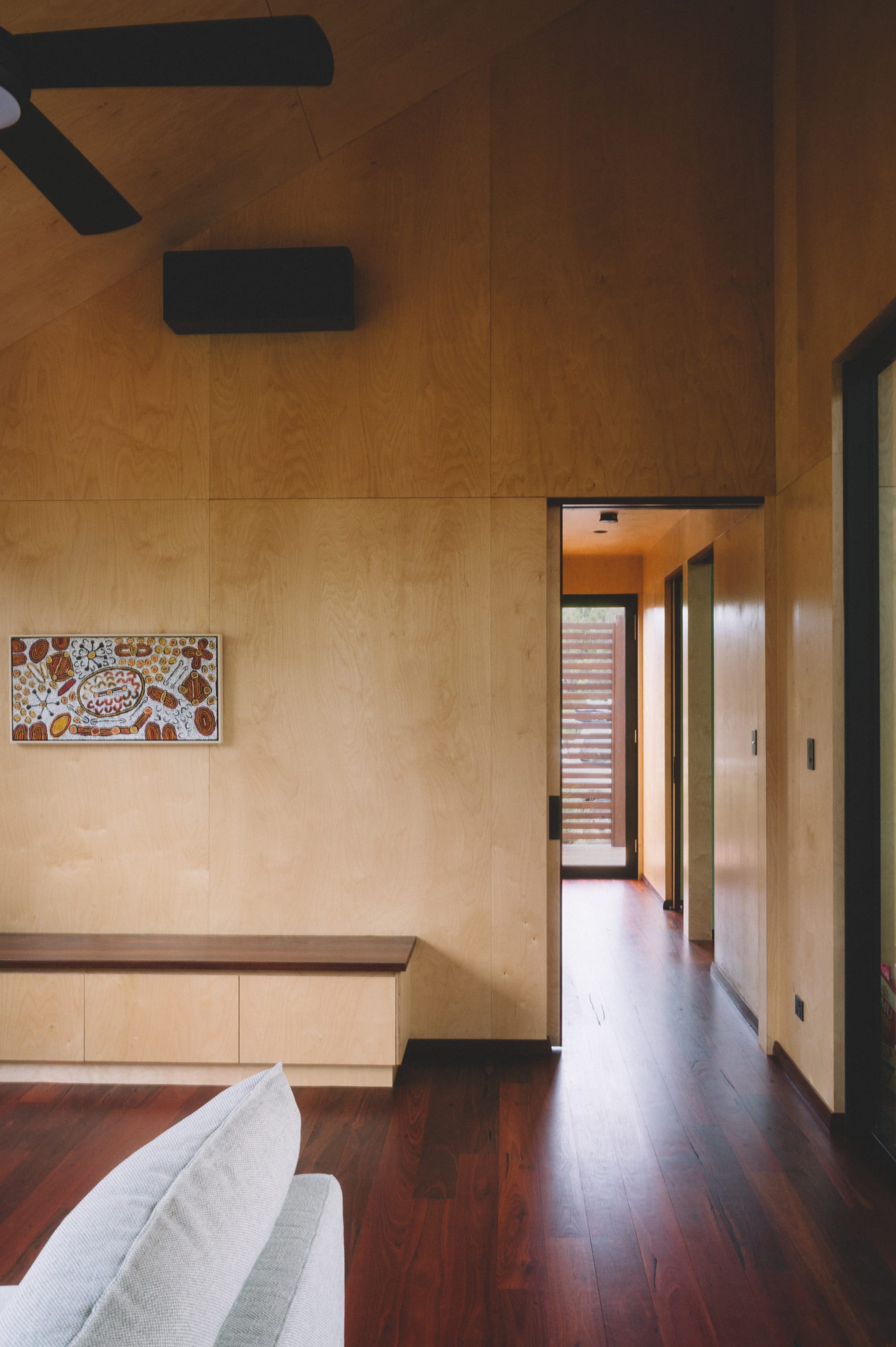 Nullaki House by Bare Architects. Minimalistic living room with Japanese aesthetic and view to corridor.