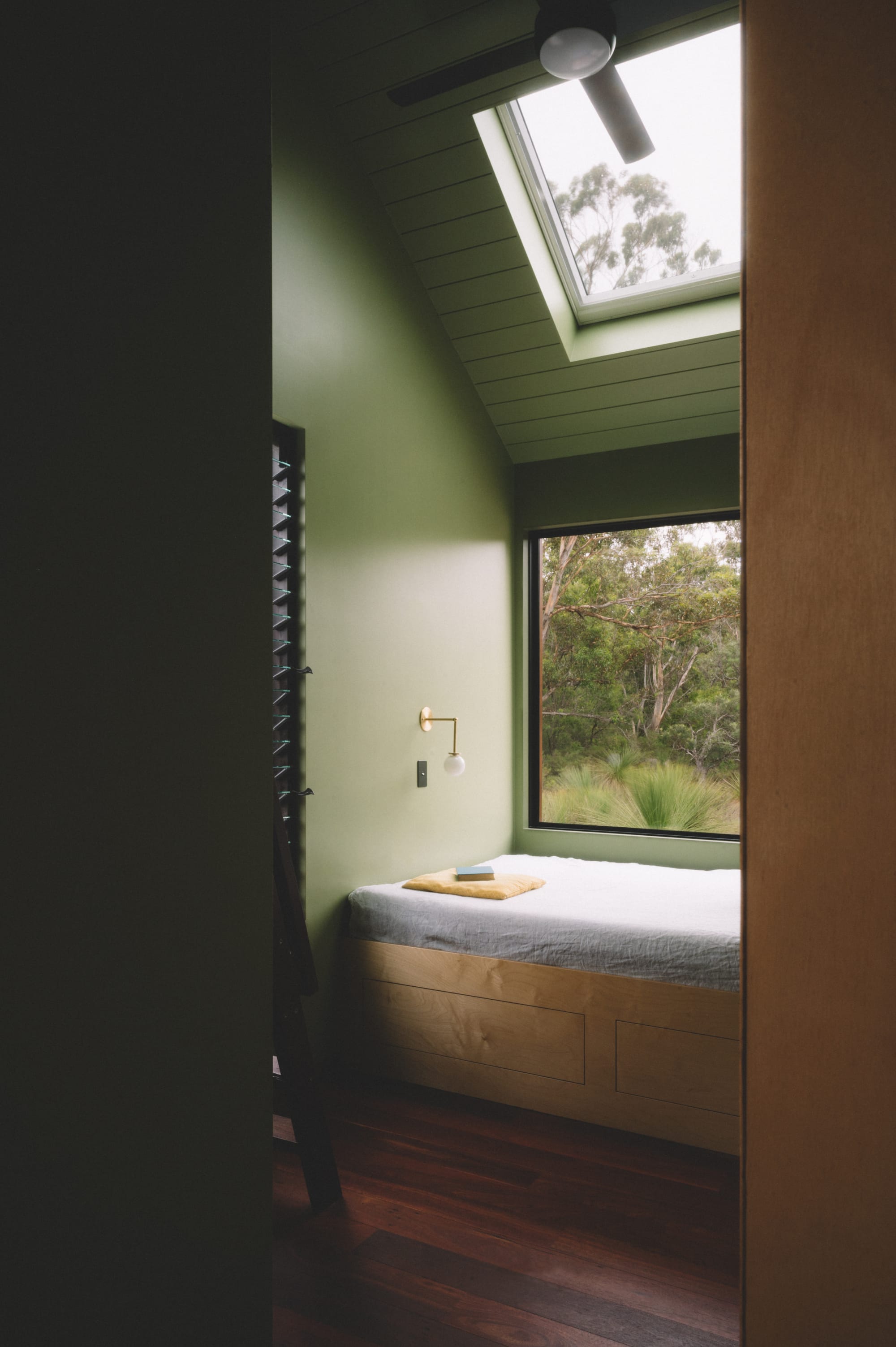 Nullaki House by Bare Architects. Bedroom view with built-in cabinets and view to nature.