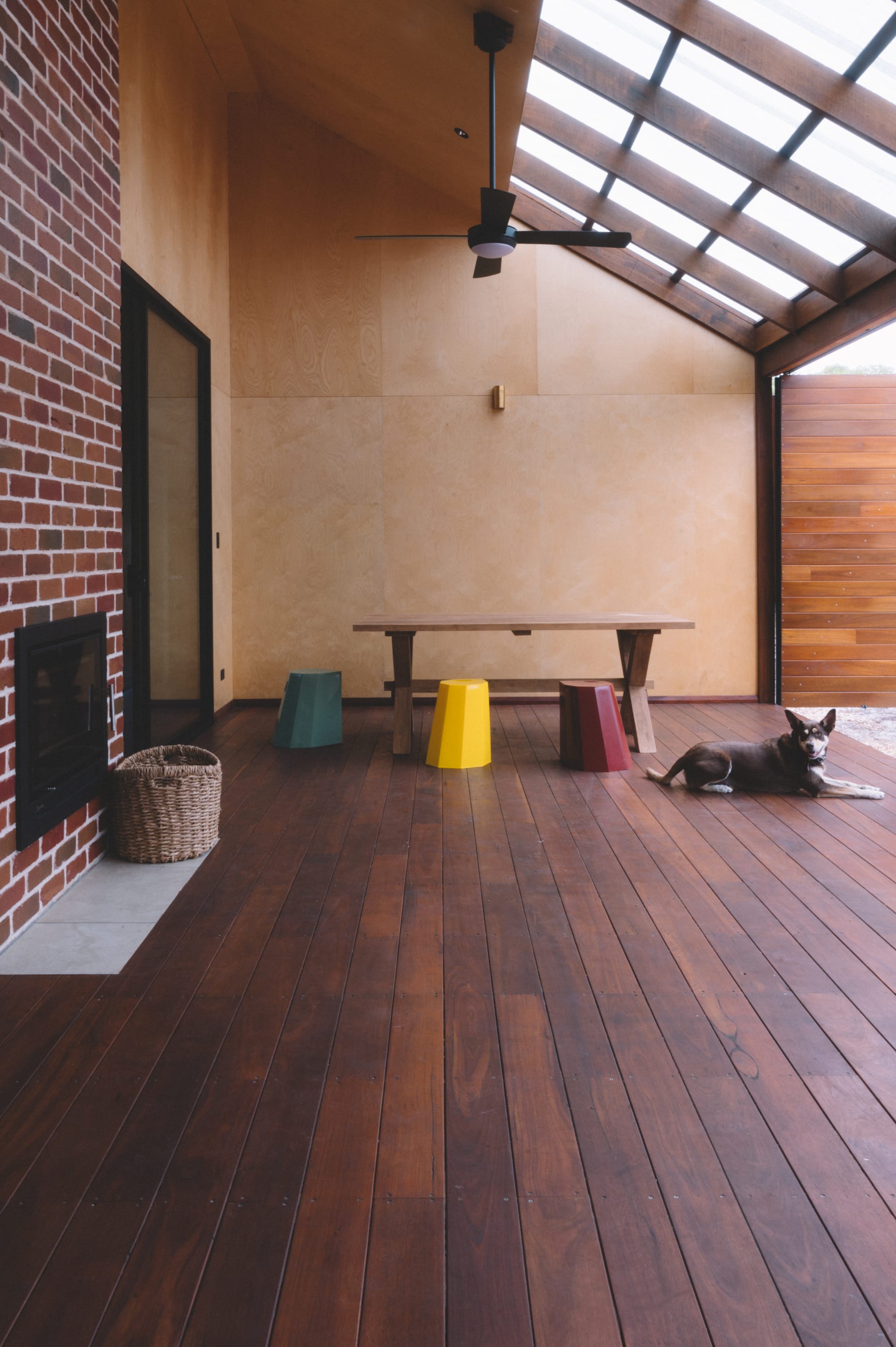 Nullaki House by Bare Architects. Terrace with seating area and fireplace connected to landscape.