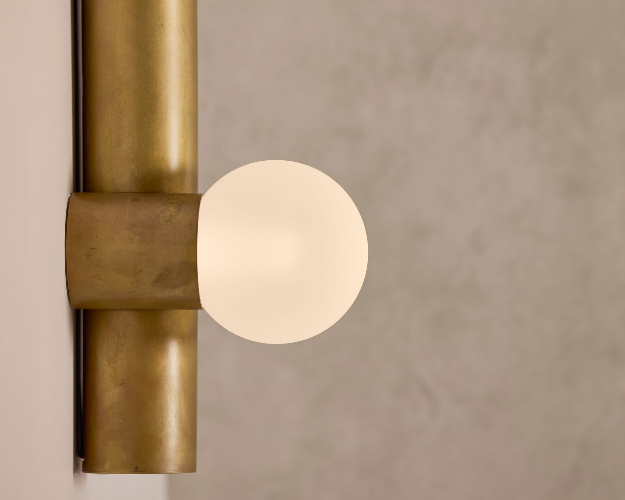 Globe Tube Wall Light by alt. Artefact. Brushed brass globe tube wall light.