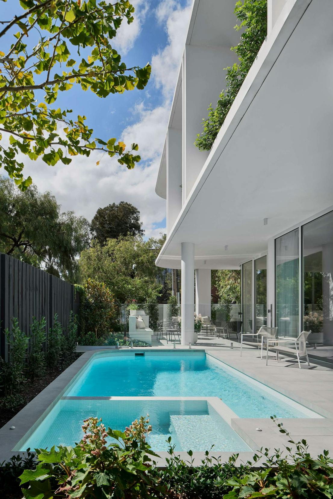 Brighton Apartments by Merrylees Architects. Outside space featuring pool and building structure with floor to ceiling windows.