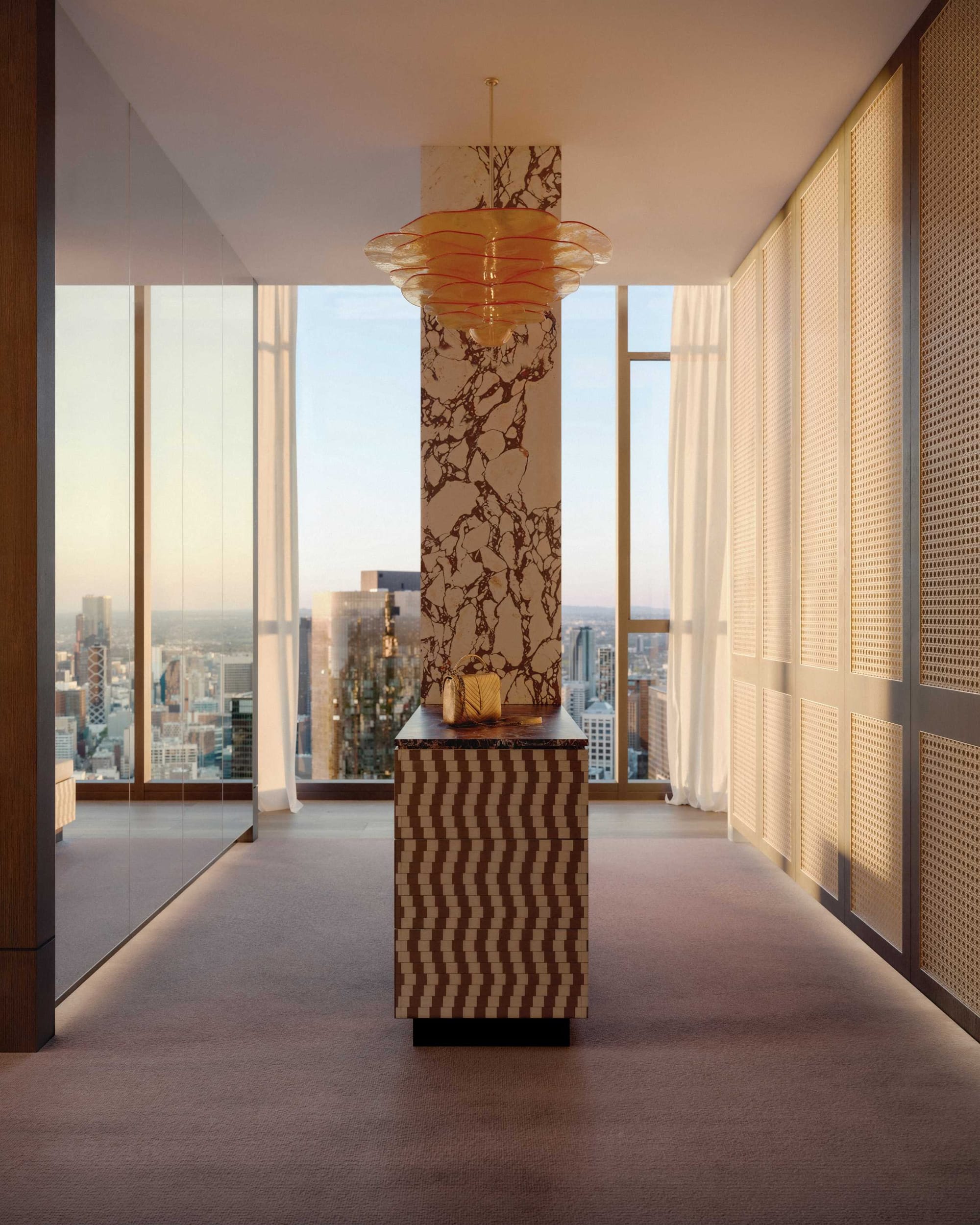 BLVD Penthouse by David Hicks. Luxury walk-in wardrobe featuring rattan and mirrored fitted cabinets and floor to ceiling windows with view on city.