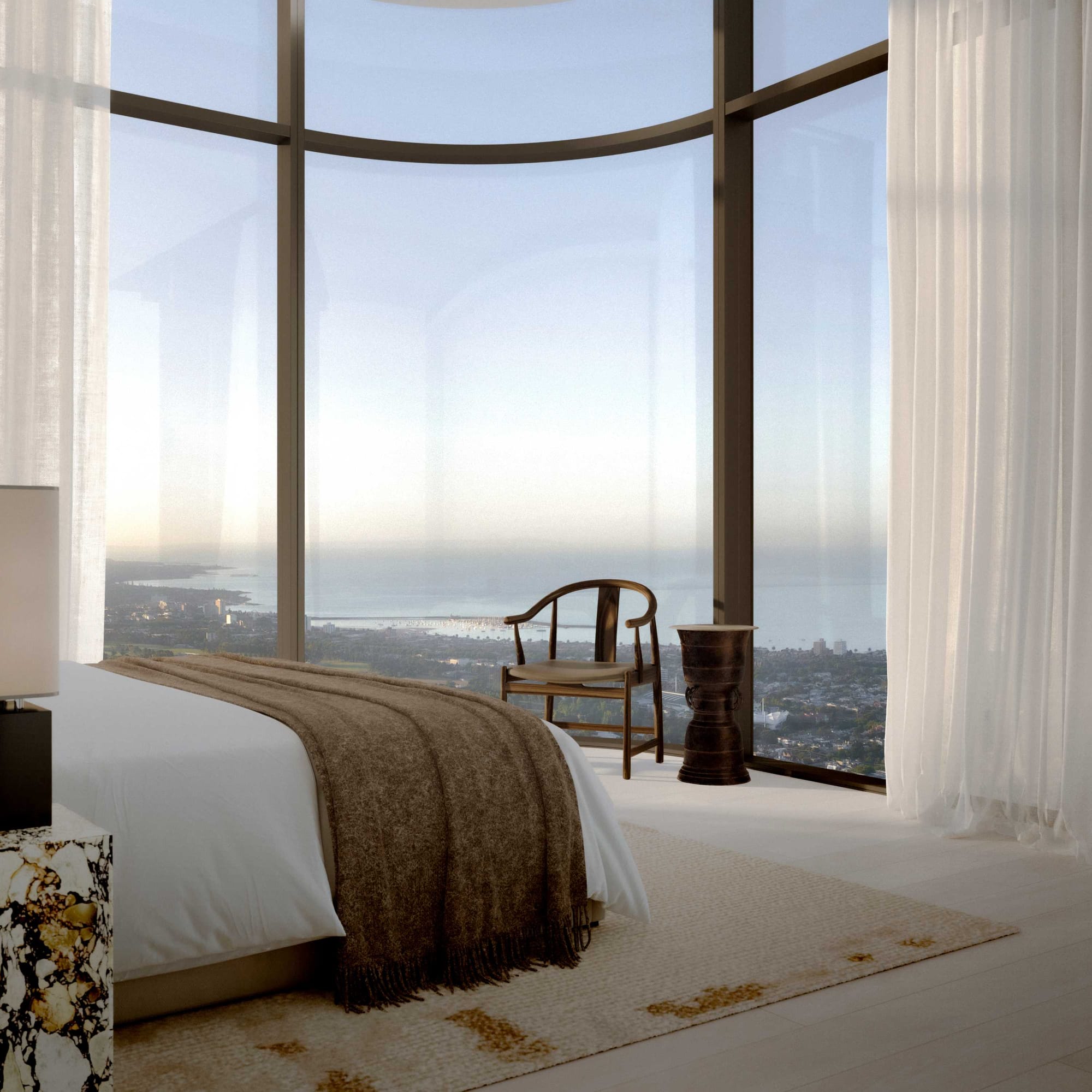 BLVD Penthouse by David Hicks. Luxury bedroom featuring curved, floor to ceiling window and view to coastline.