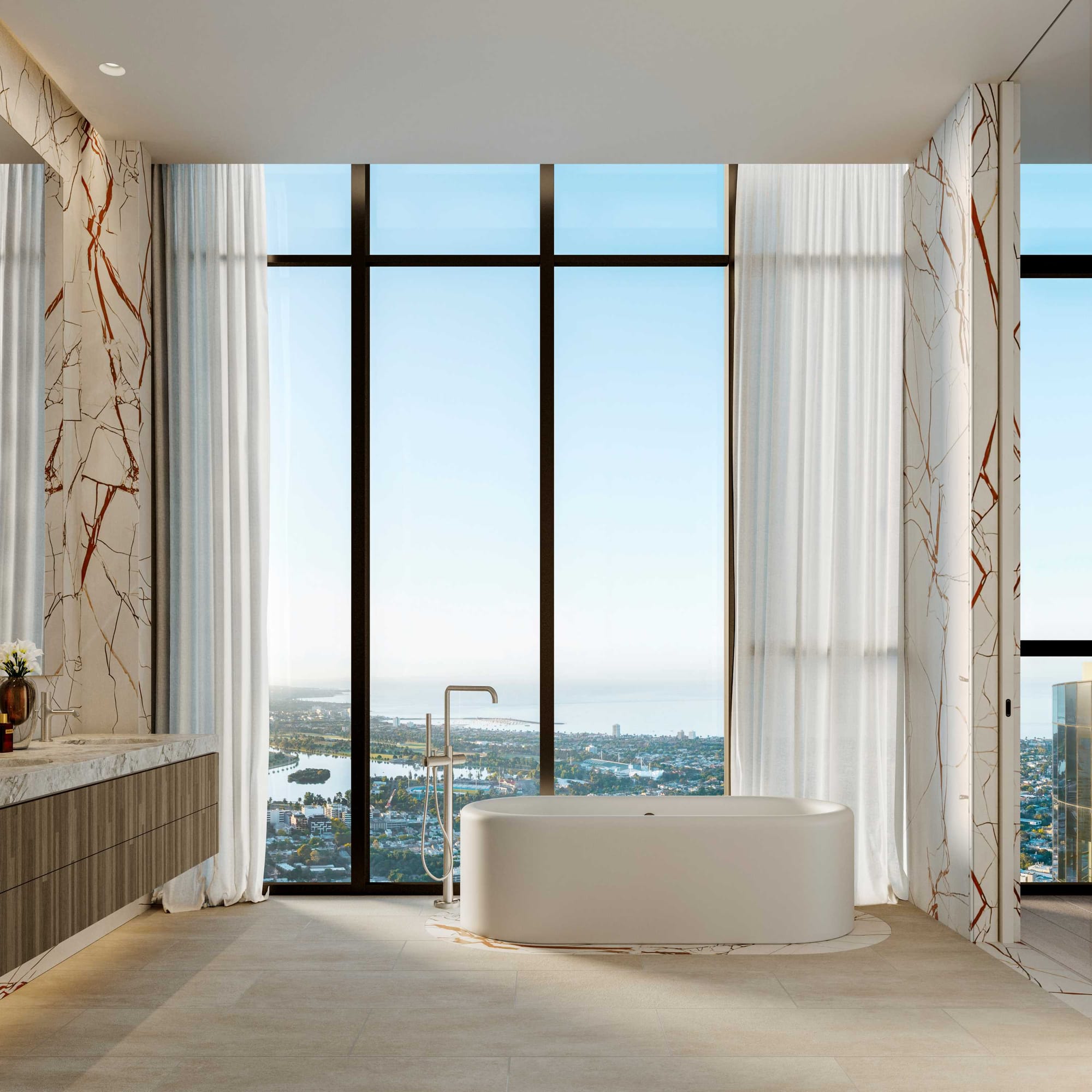 BLVD Penthouse by David Hicks. Luxury bathroom featuring free standing bathtub and marble walls with floor to ceiling windows and view to coastline.