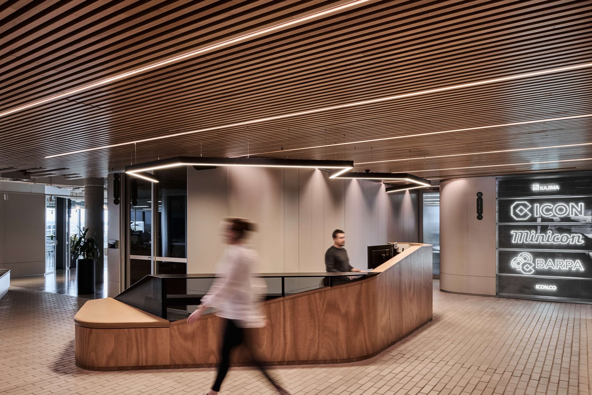 Icon HQ by FIGR. Wooden office information desk featuring rounded corners.