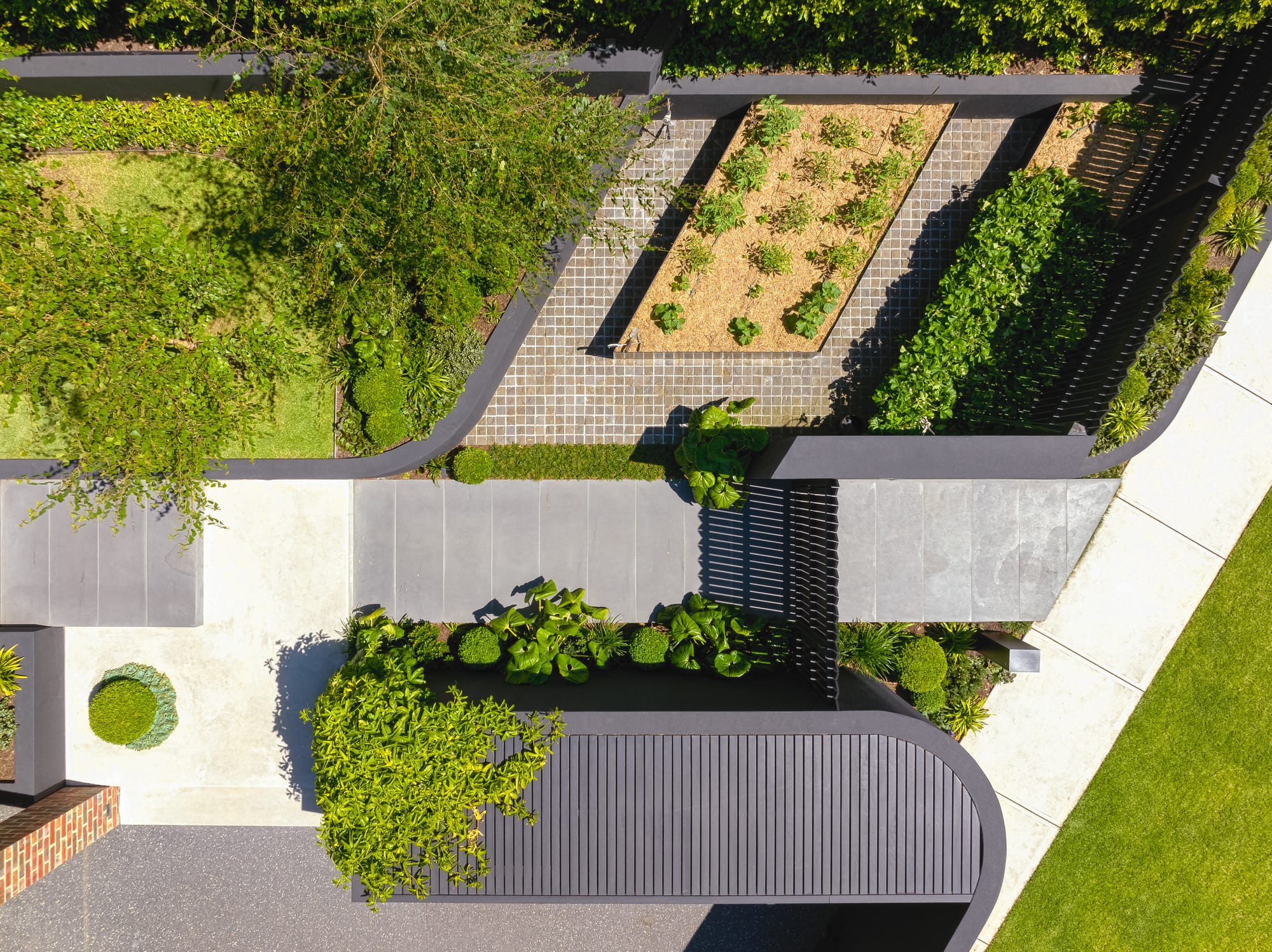 A birds eye shot of the property showing an overview of the family residence and external gardens.