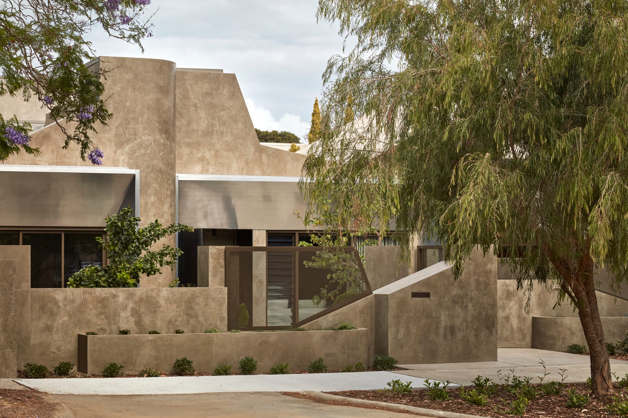 Proclamation House by State of Kin. Modern contemporary family home featuring hempcrete facade, aluminium awnings blend into surroundings.