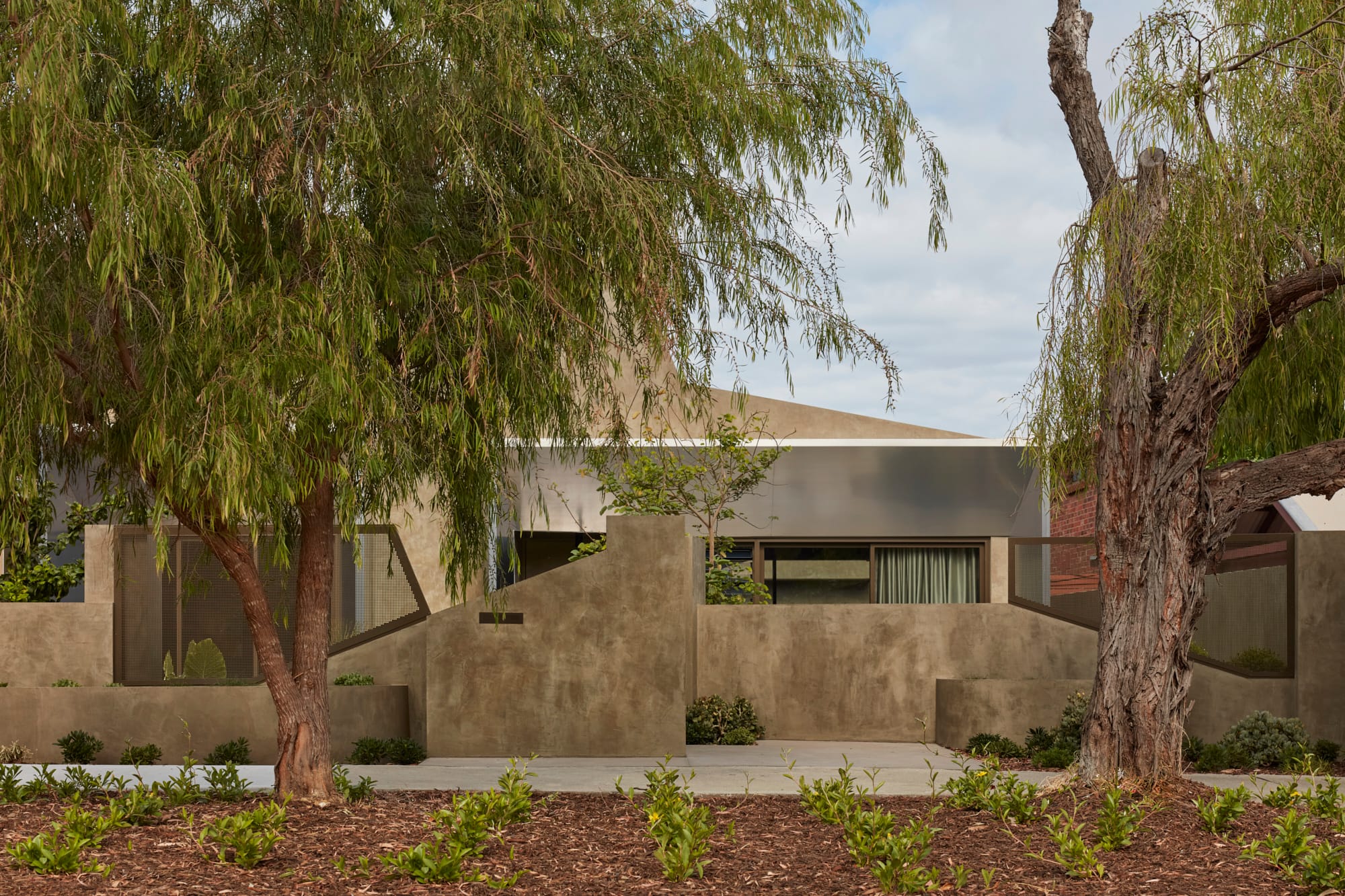 Proclamation House by State of Kin. Modern contemporary family home blending into surroundings featuring peppermint trees.