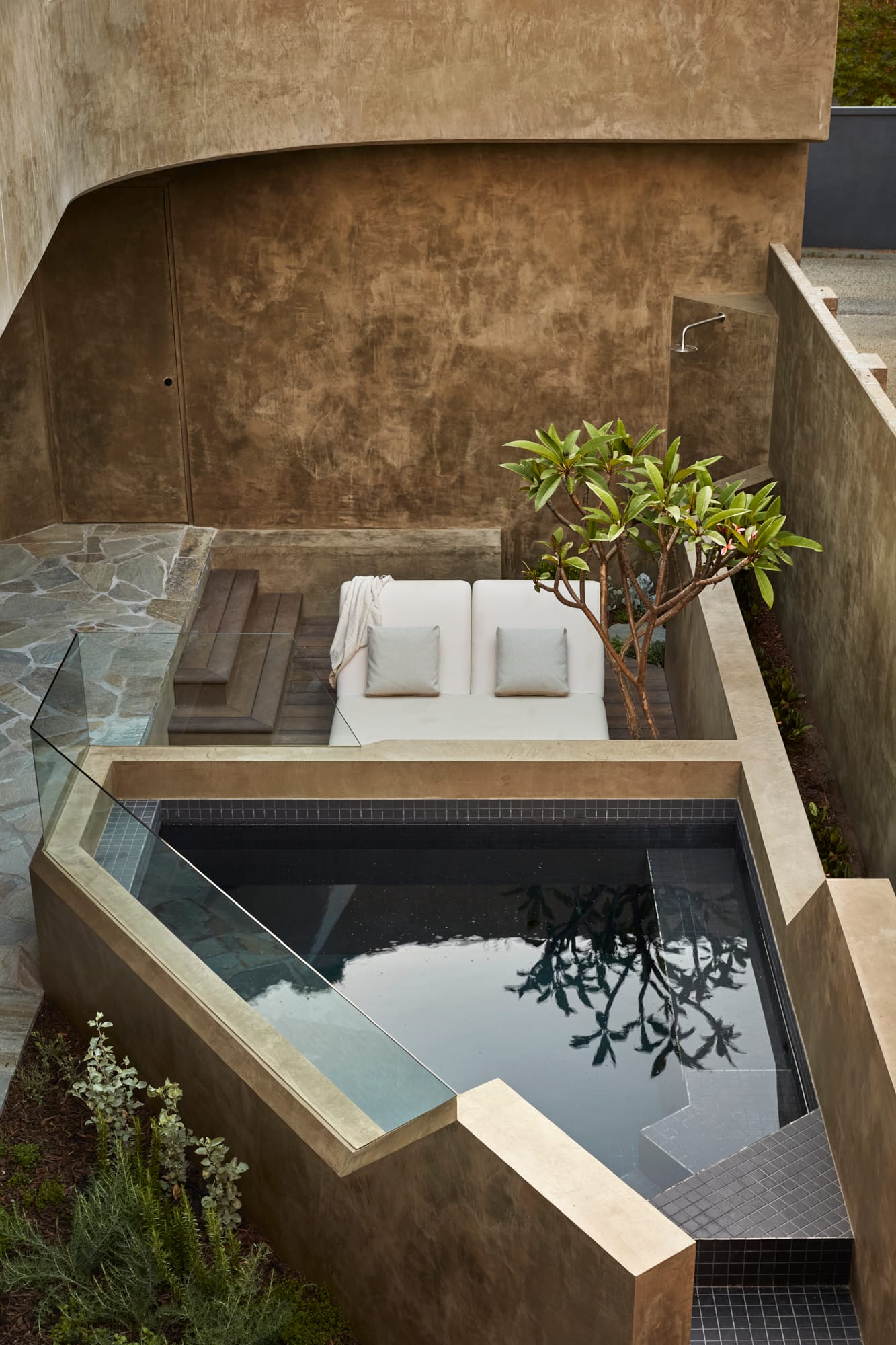 Proclamation House by State of Kin. View to pool and lounge area featuring hempcrete walls.