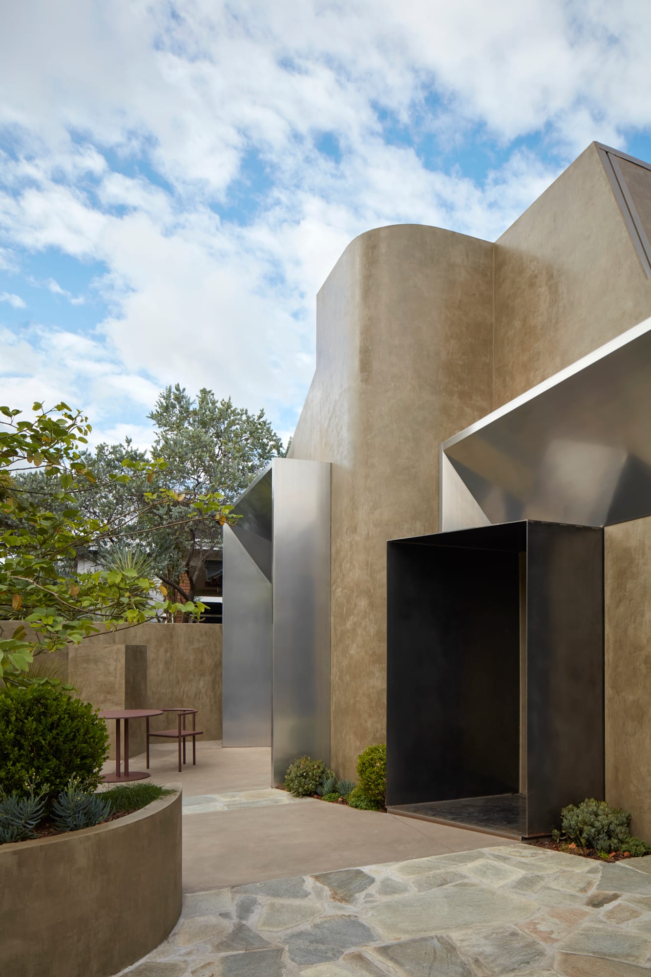 Proclamation House by State of Kin. Inner courtyard with view to modern contemporary facade featuring aluminium framed entrances.