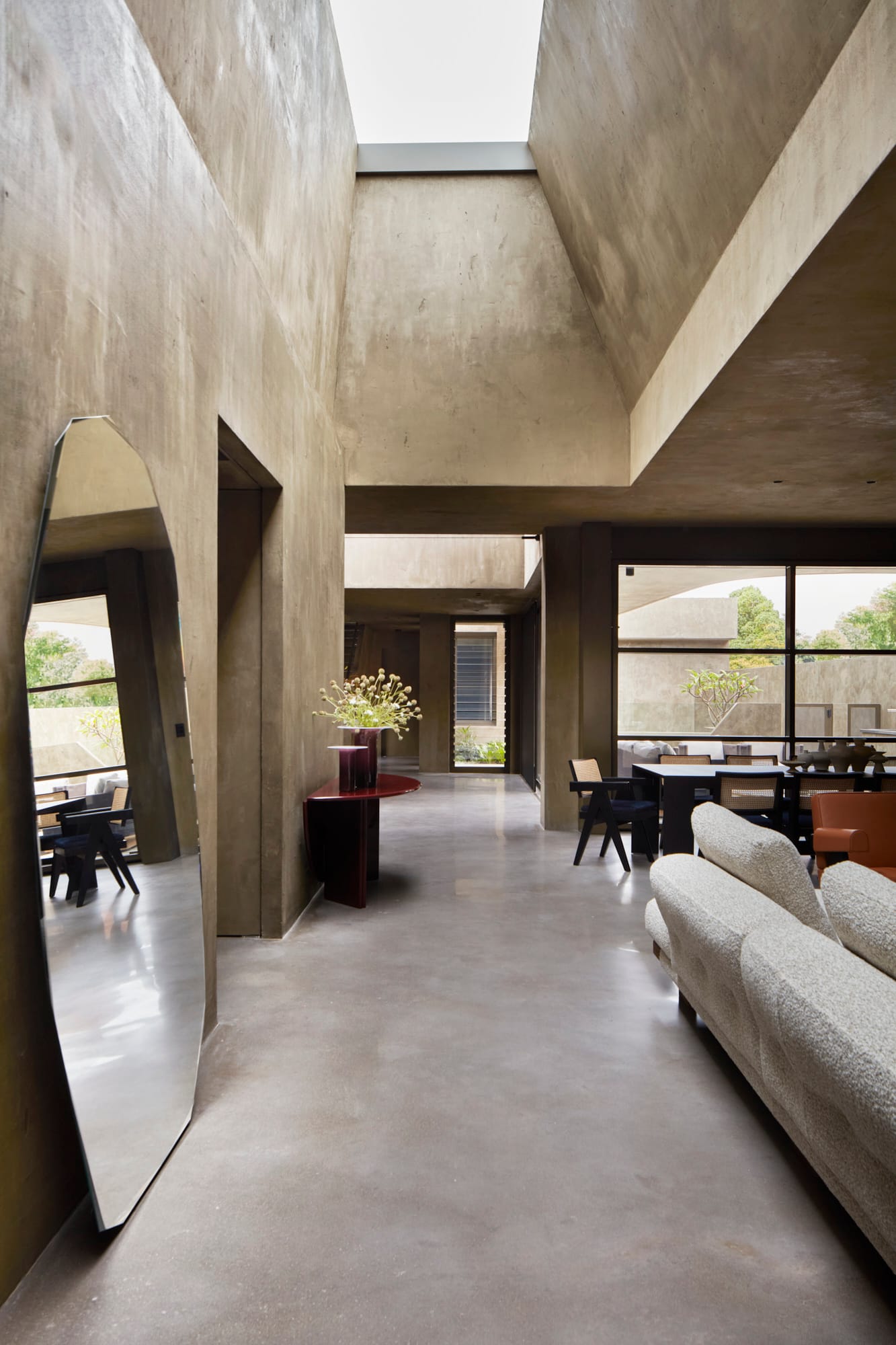 Proclamation House by State of Kin. Modern contemporary interior featuring peeked roof with ceiling light and olive-hemp blend walls.