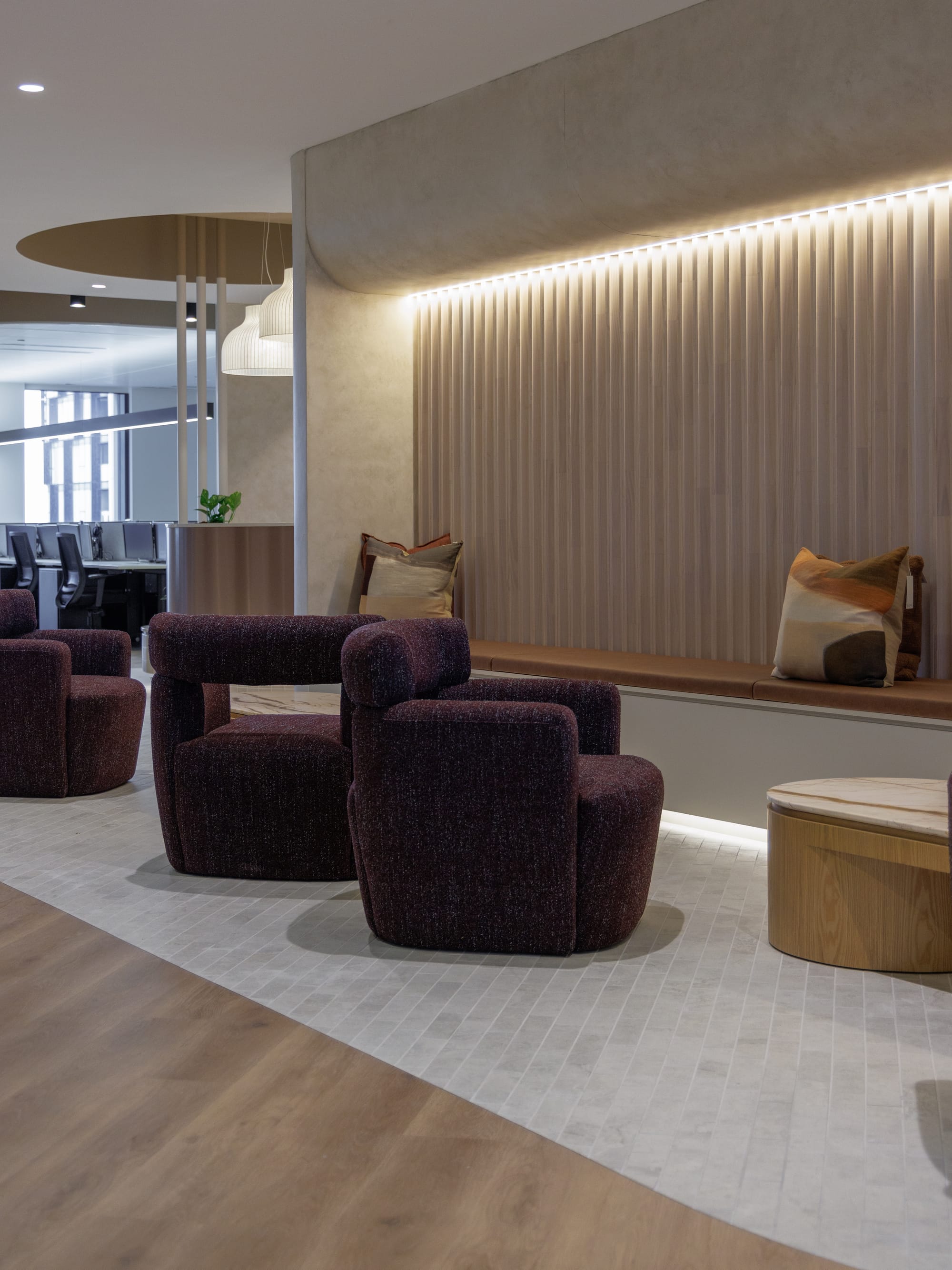 St Leonards Centuria Office Fit-Out by Alinea. Office lounge area featuring build in bench and purple armchairs.