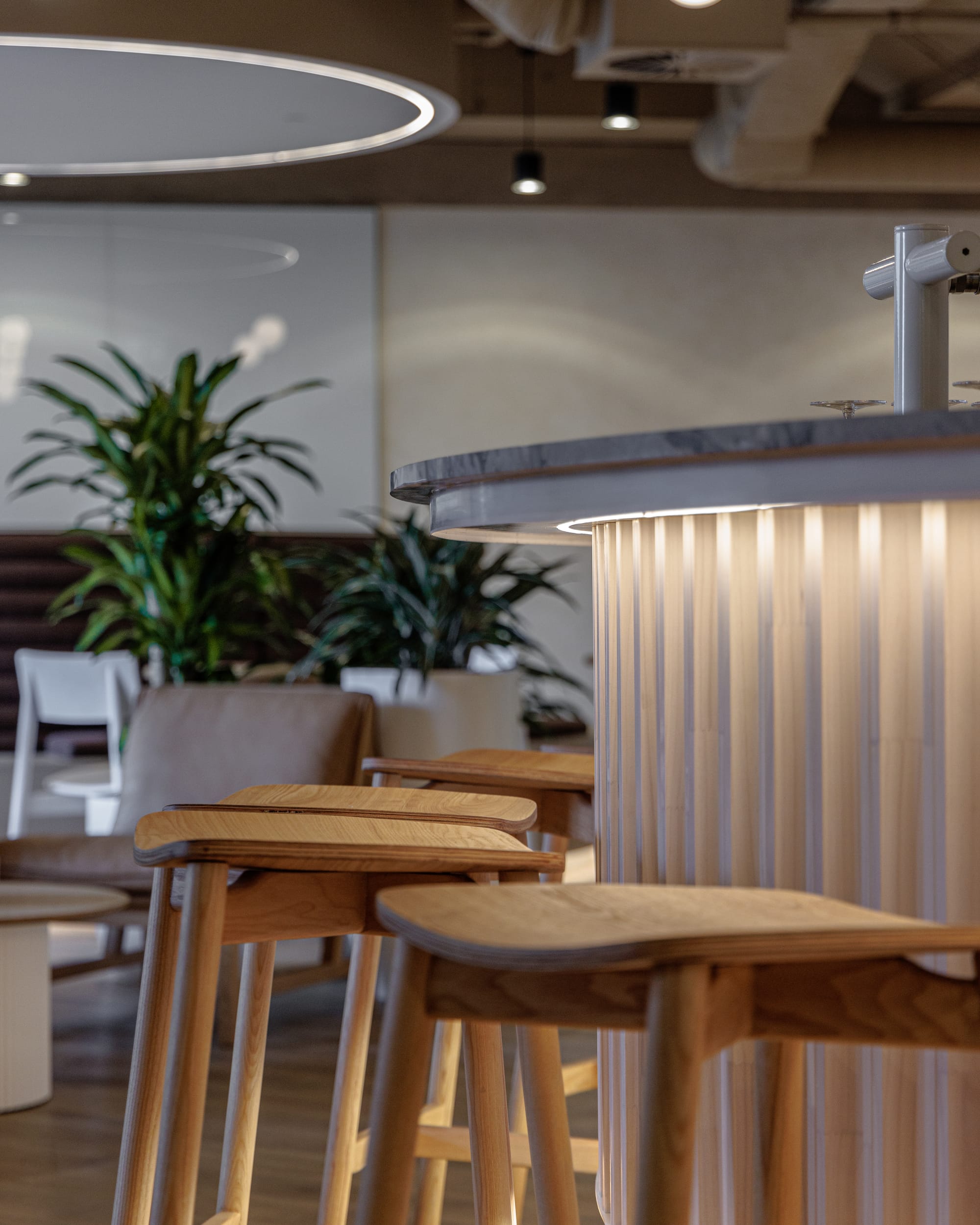 St Leonards Centuria Office Fit-Out by Alinea. Customised and illuminated kitchen bar detail featuring wooden bar chairs.