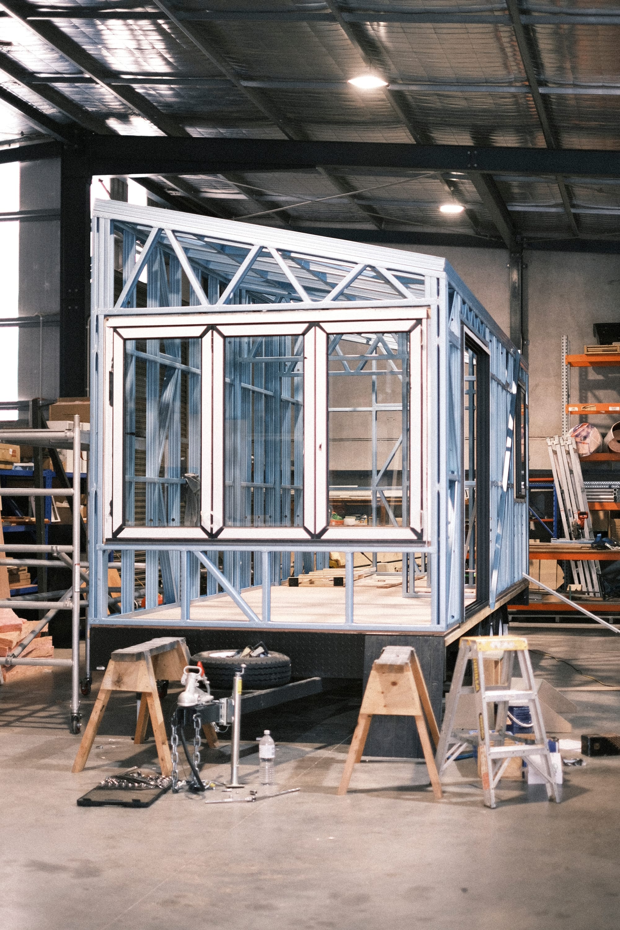 Workshop at Base Cabin. Workshop environment featuring steel framed tiny house on trailer.