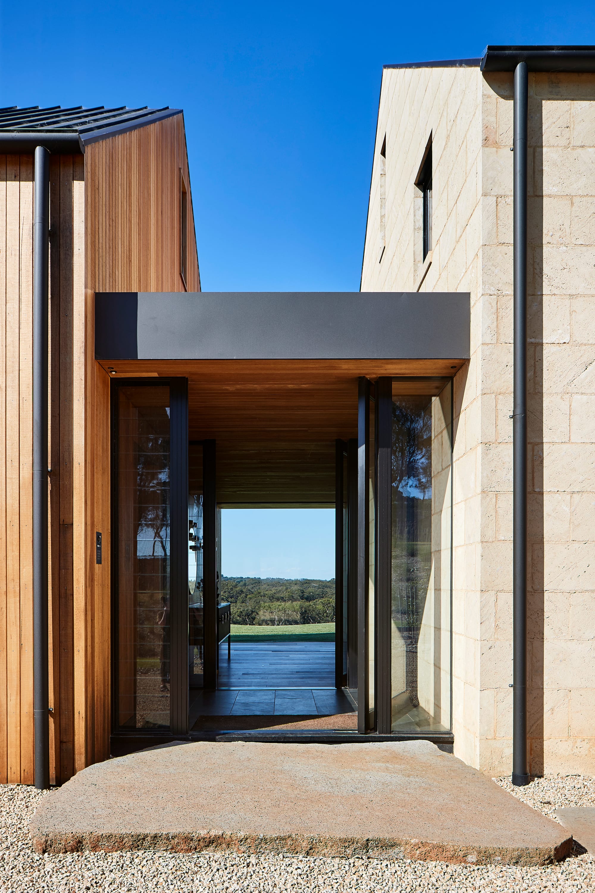 Flinders Residence by Abe McCarthy. Two modern houses connected through passerelle with view to surrounding landscape.