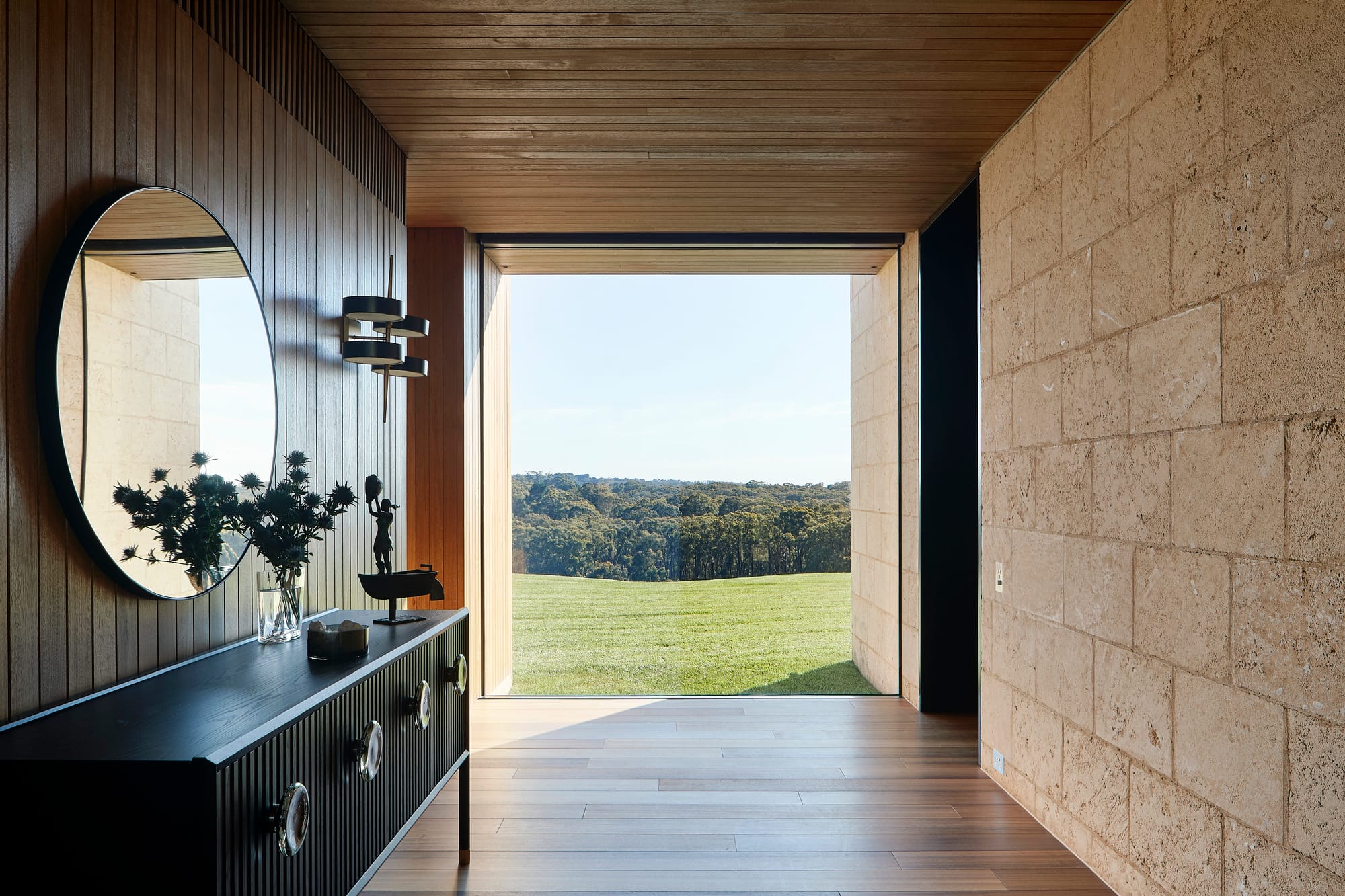 Flinders Residence by Abe McCarthy. Modern residence interior with farmhouse charm hallway featuring view to nature.