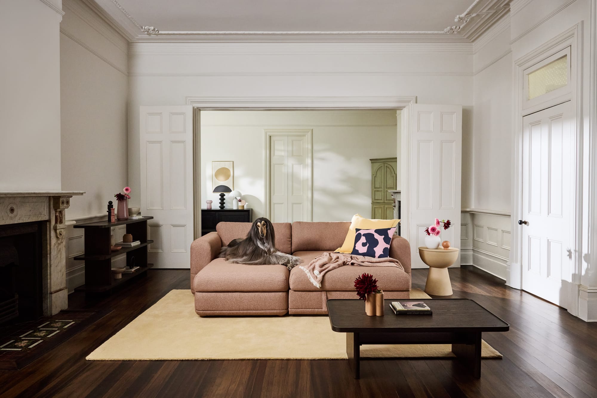 Koala Wanda Sofa Bed in pink with a dog laying on it