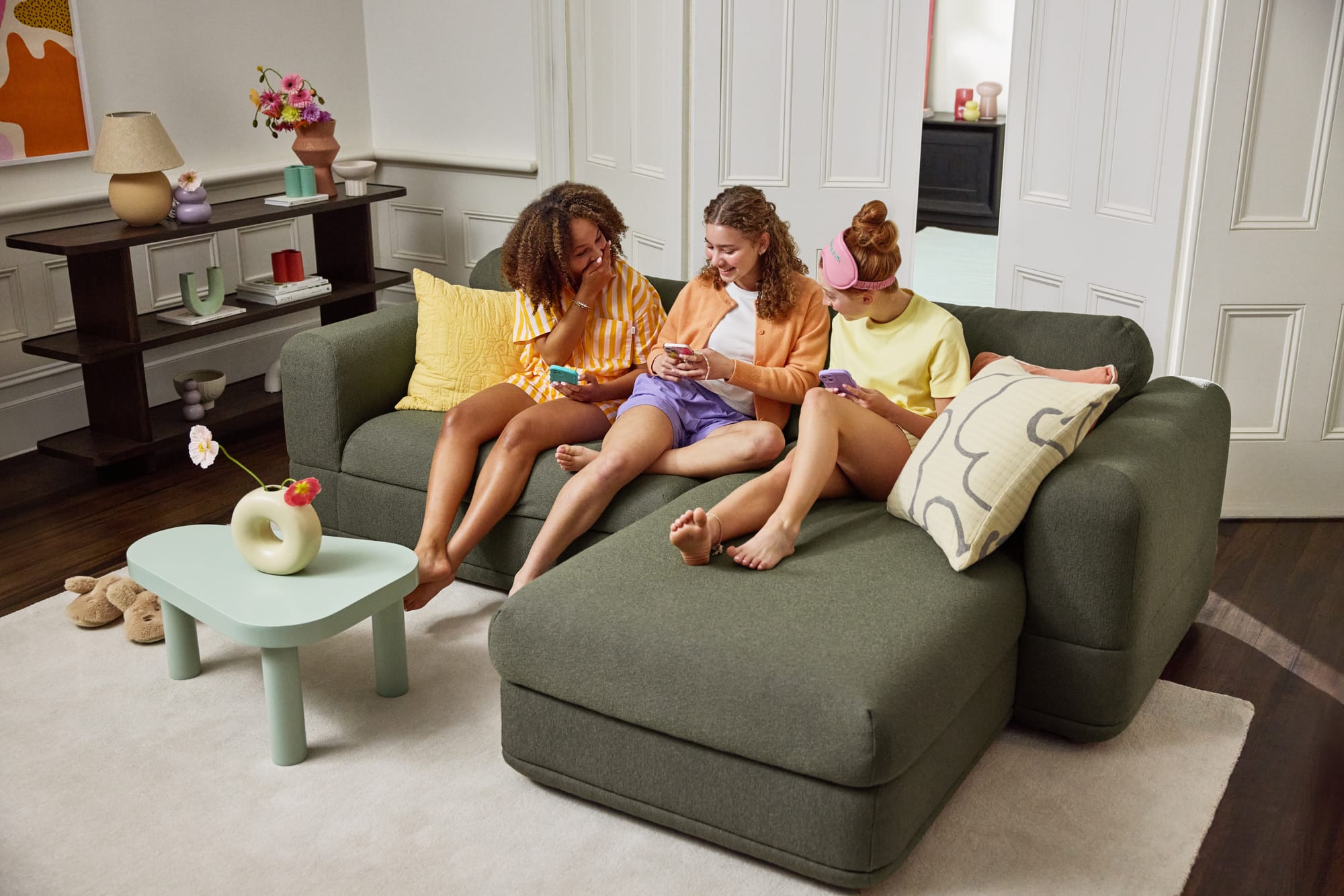 Koala Wanda Sofa Bed in green with three girls sitting on it