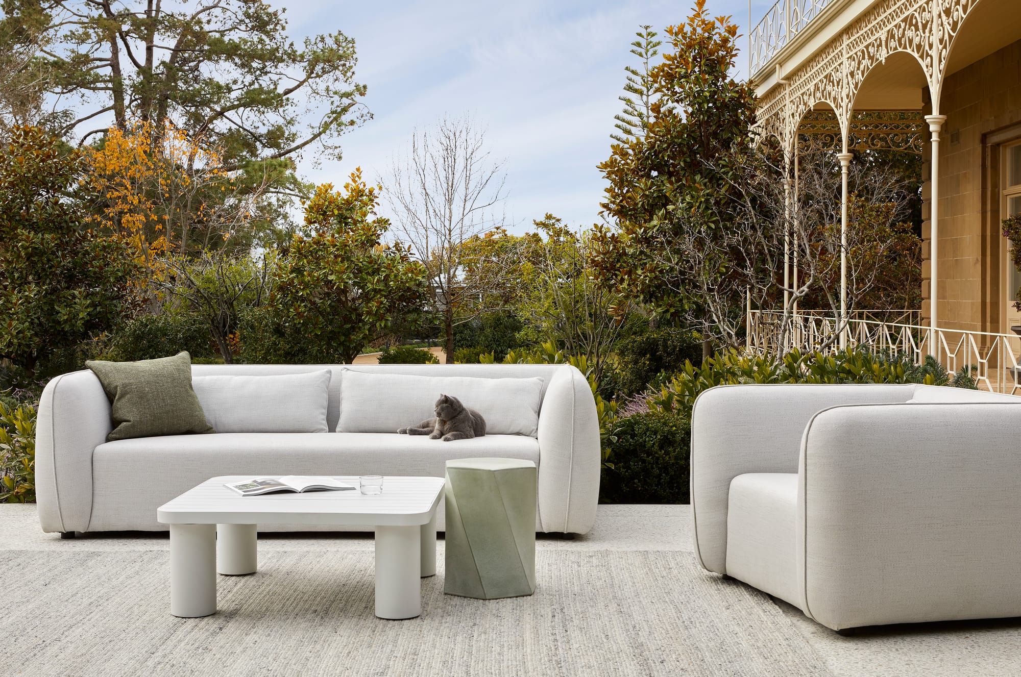 Melba Outdoor Dining Table & Dining Chairs by GlobeWest. Dining set at pool in front of Mediterranean house with garden.