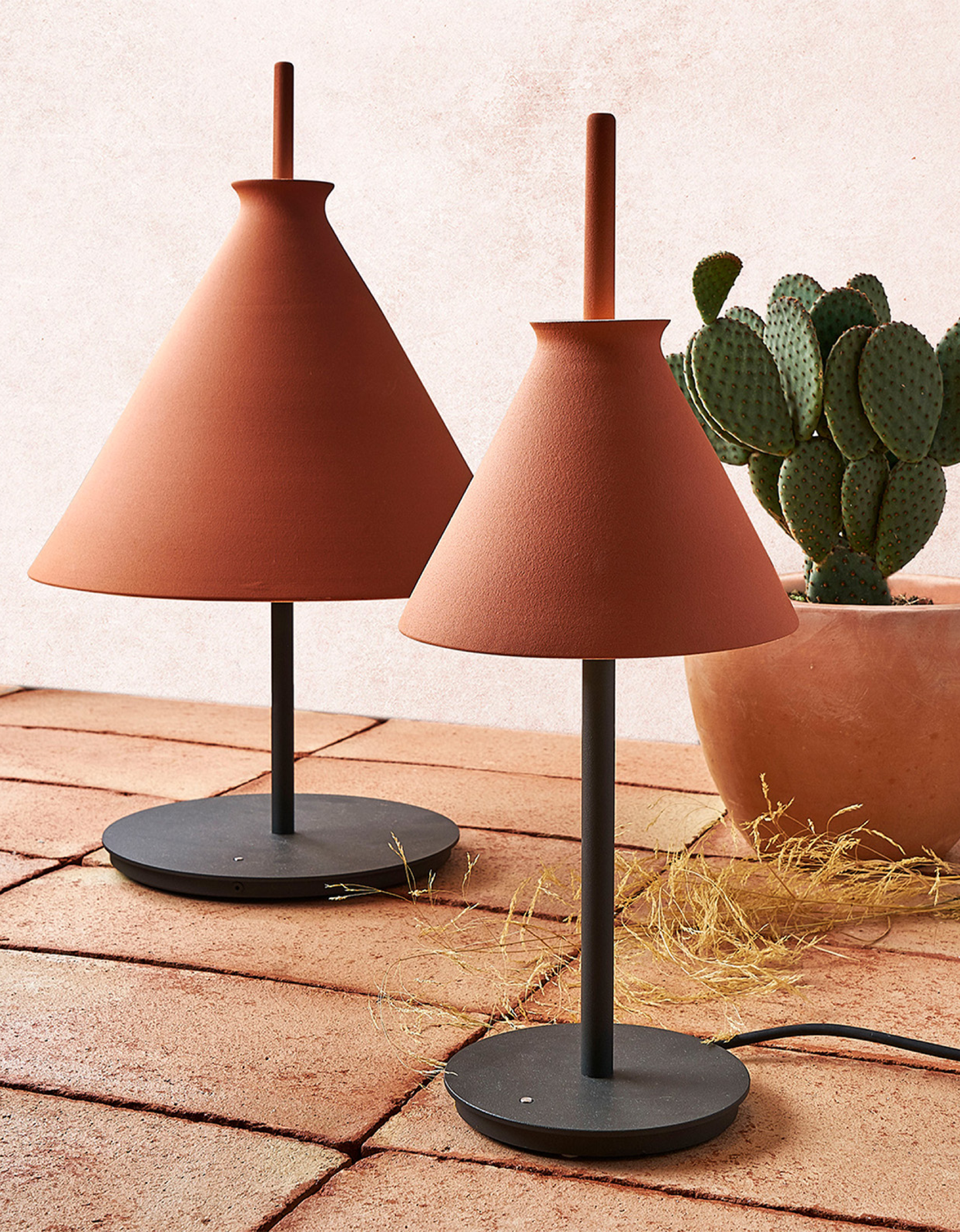 Totana Table Lamp by Kaylie with Lighterior. Cylinder shaped clay table lamp in featuring black powder coated metal stand.