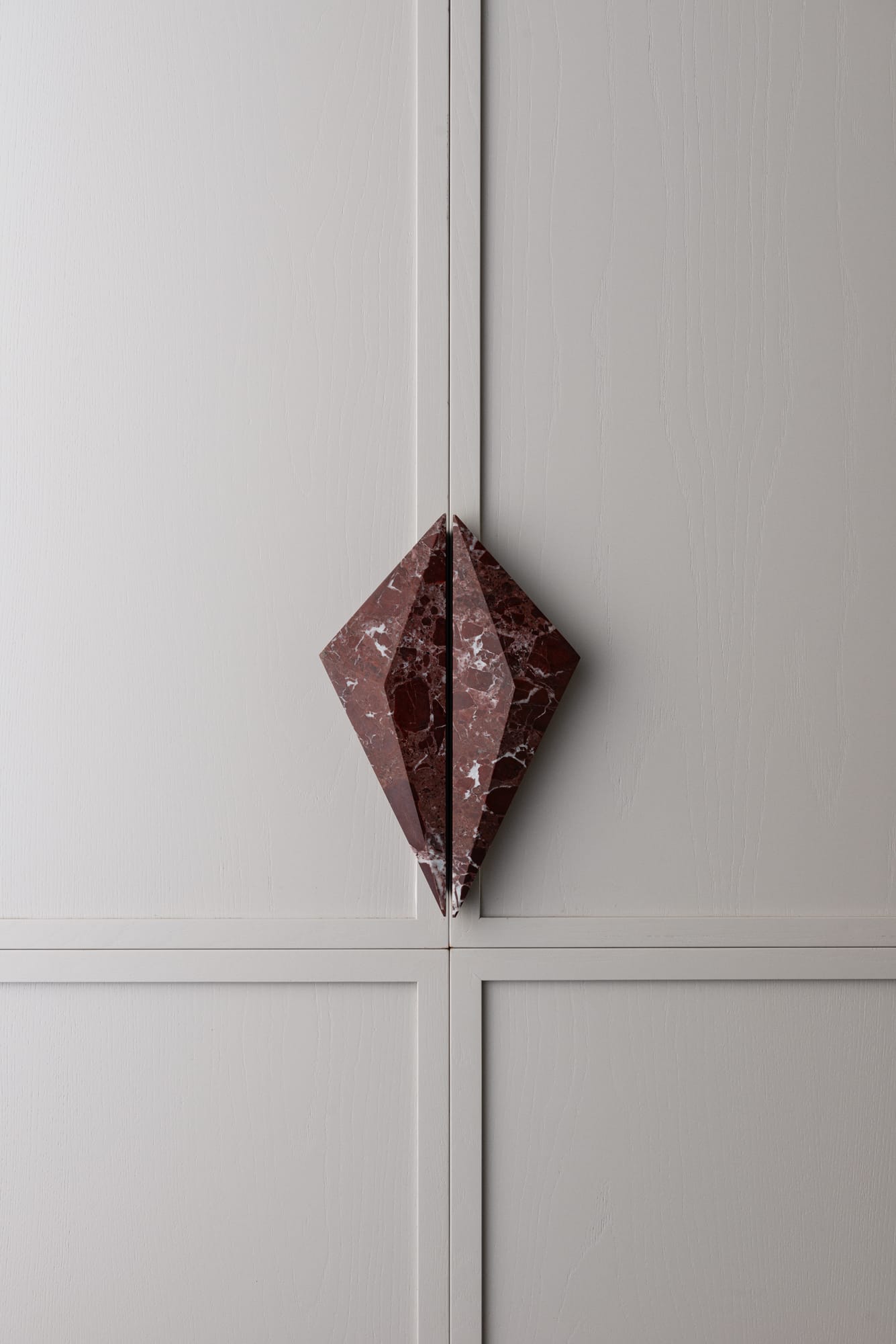 PRISM collection by Lo & Co. Showing the designer door ware on some grey cabinets in red marble