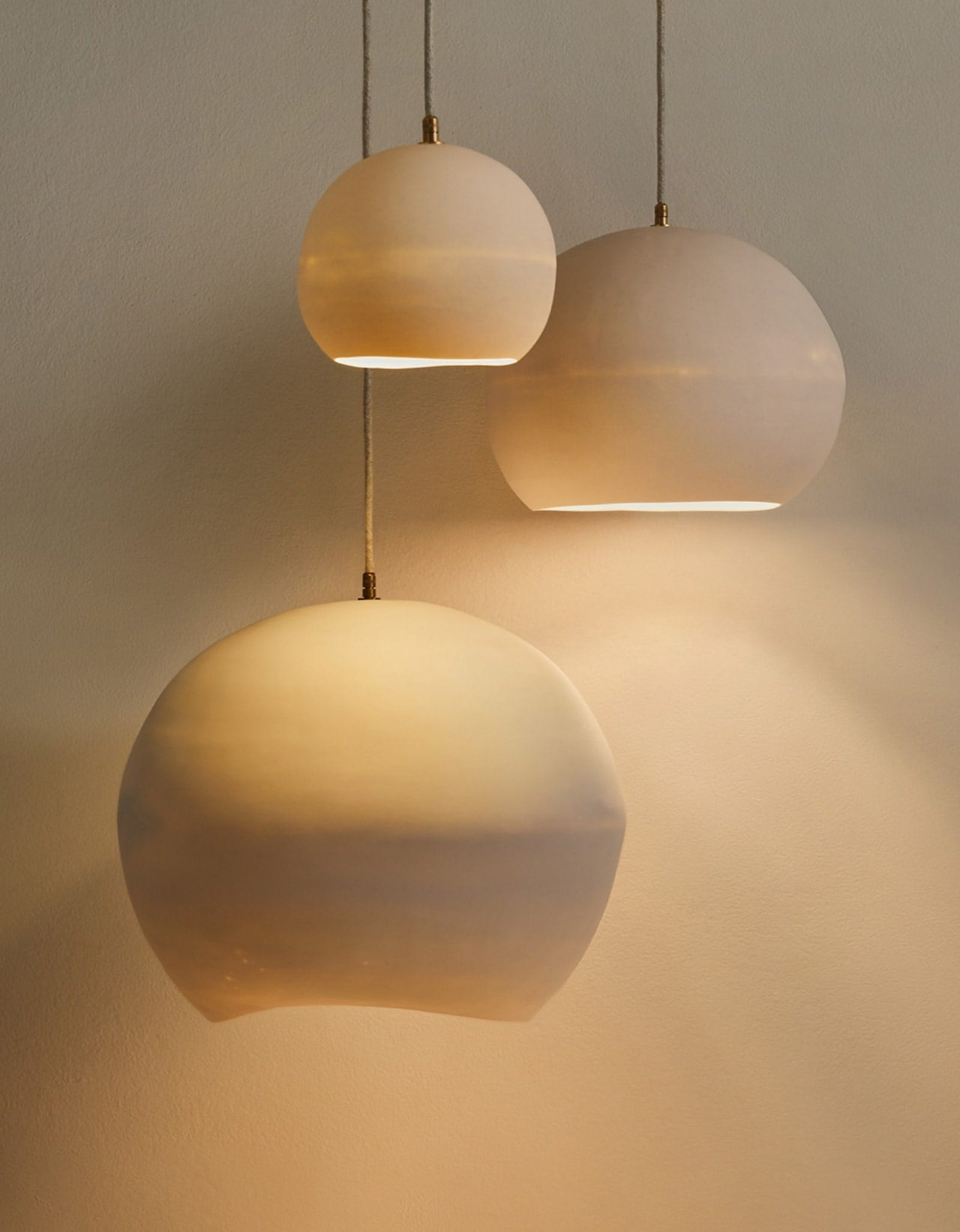 Orb Ceramic Pendant Light by Studio Enti with Lighterior. Round shaped translucent  pendant light made from Australian porcelain creating warm atmosphere.