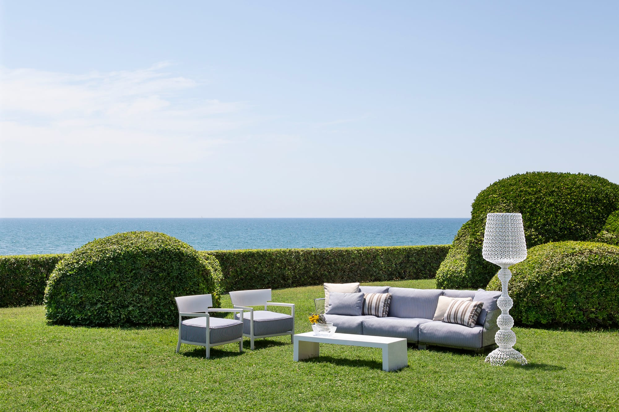 Outdoor Collection Cara Outdoor Armchair by KartellPerth. Modern garden featuring outdoor lounge set including armchairs sofa, coffee table and polyurethane floor lamp.