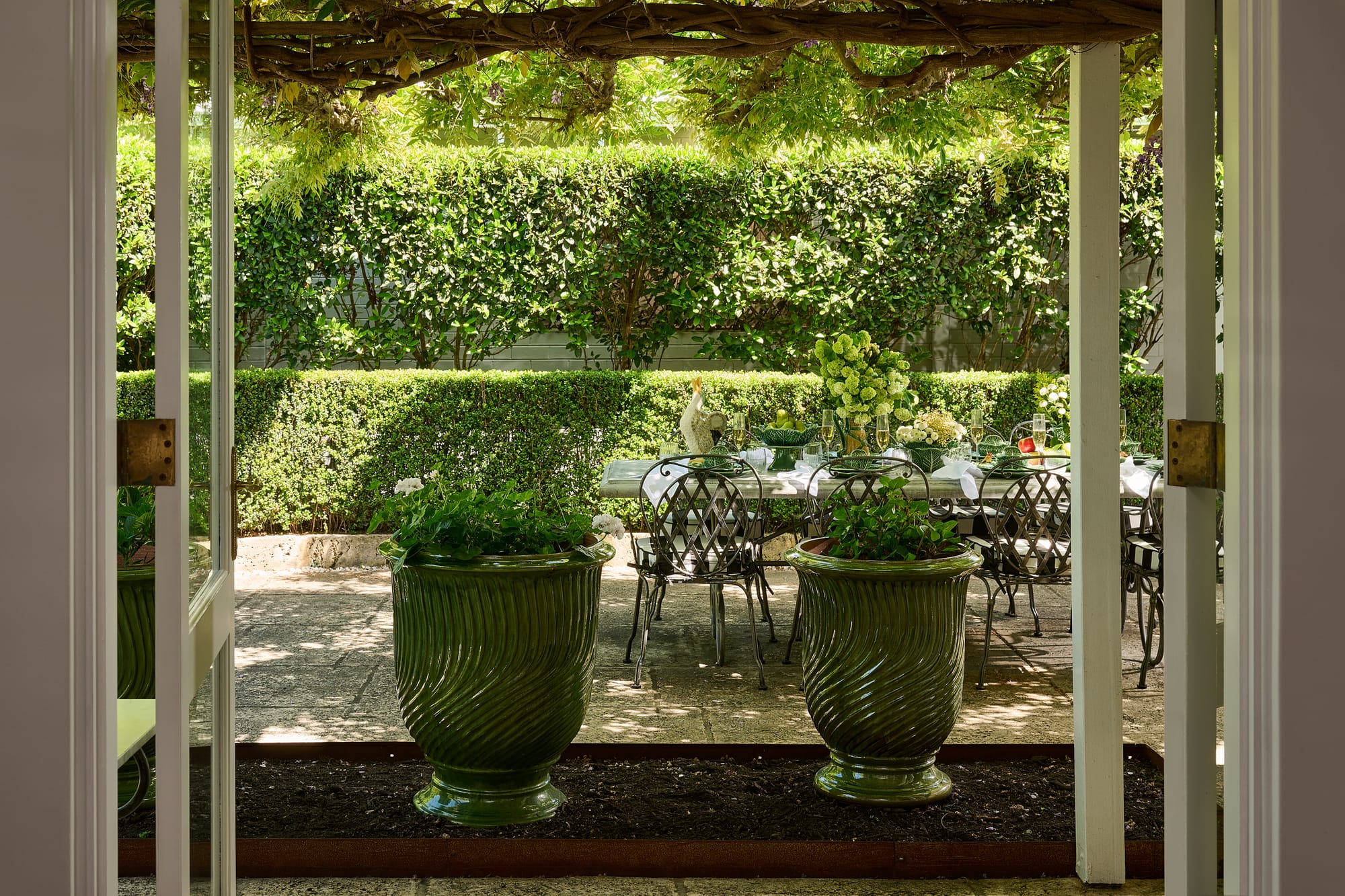 Authentic Anduze Collection Plant Pots and Le Forge Dining Collection Marseille Caver by Trilogy. View to terrace featuring big green glazed plant pots and metal Art de Nouveau  dining Set.