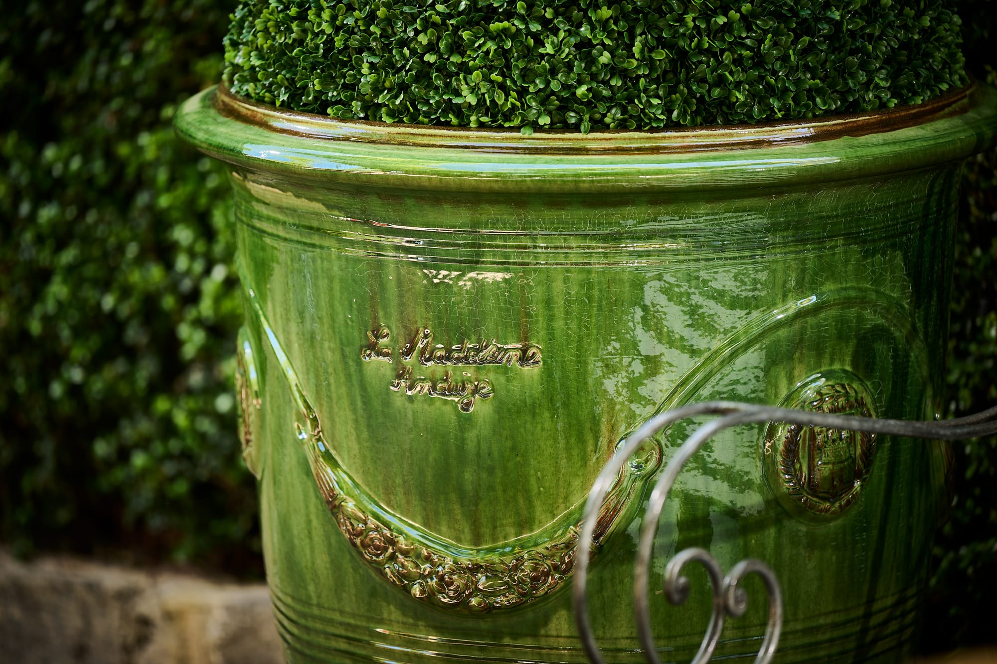 Authentic Anduze Collection Plant Pod by Trilogy. Big outdoor clay plant pot green glazed featuring emblem.