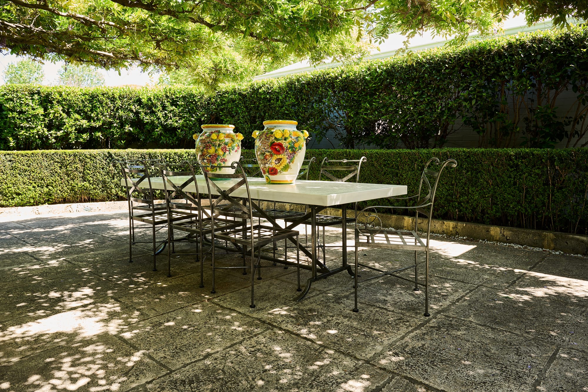 Positano Ceramic Collection Plant Pots, Le Forge Collection Napoli Side Chair and Dining Table by Trilogy. Metal Art de Nouveau dining set and ceramic hand painted plant pots in Mediterranean style.