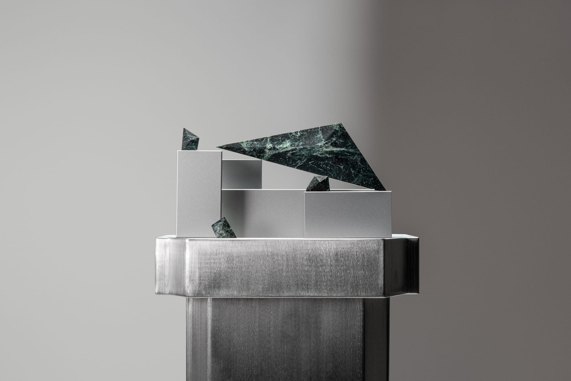 PRISM collection by Lo & Co. Displayed dark green marble joinery on metal console.