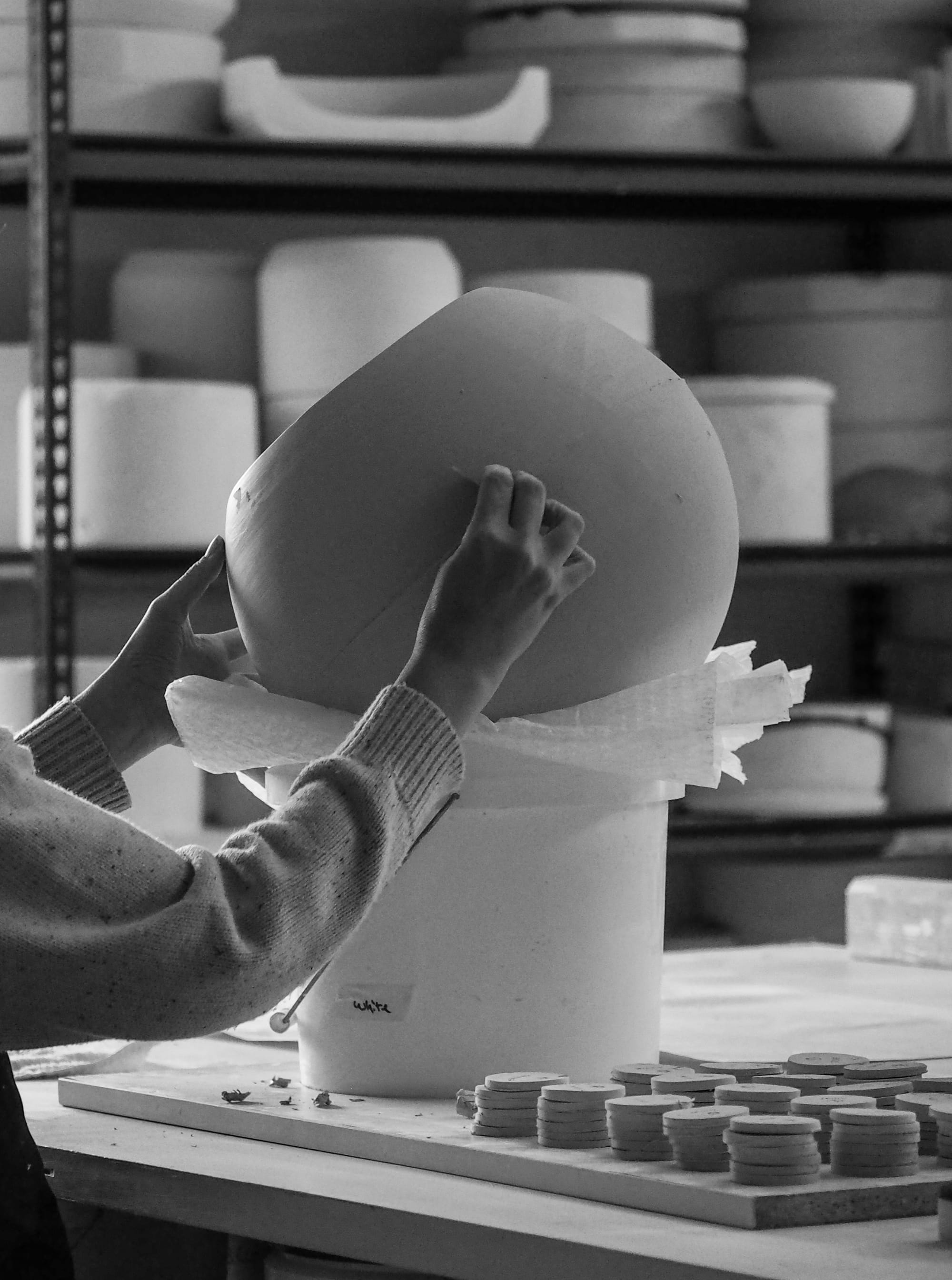 A black and white shot of an Orb Pendant light being created in the Studio Enti studio