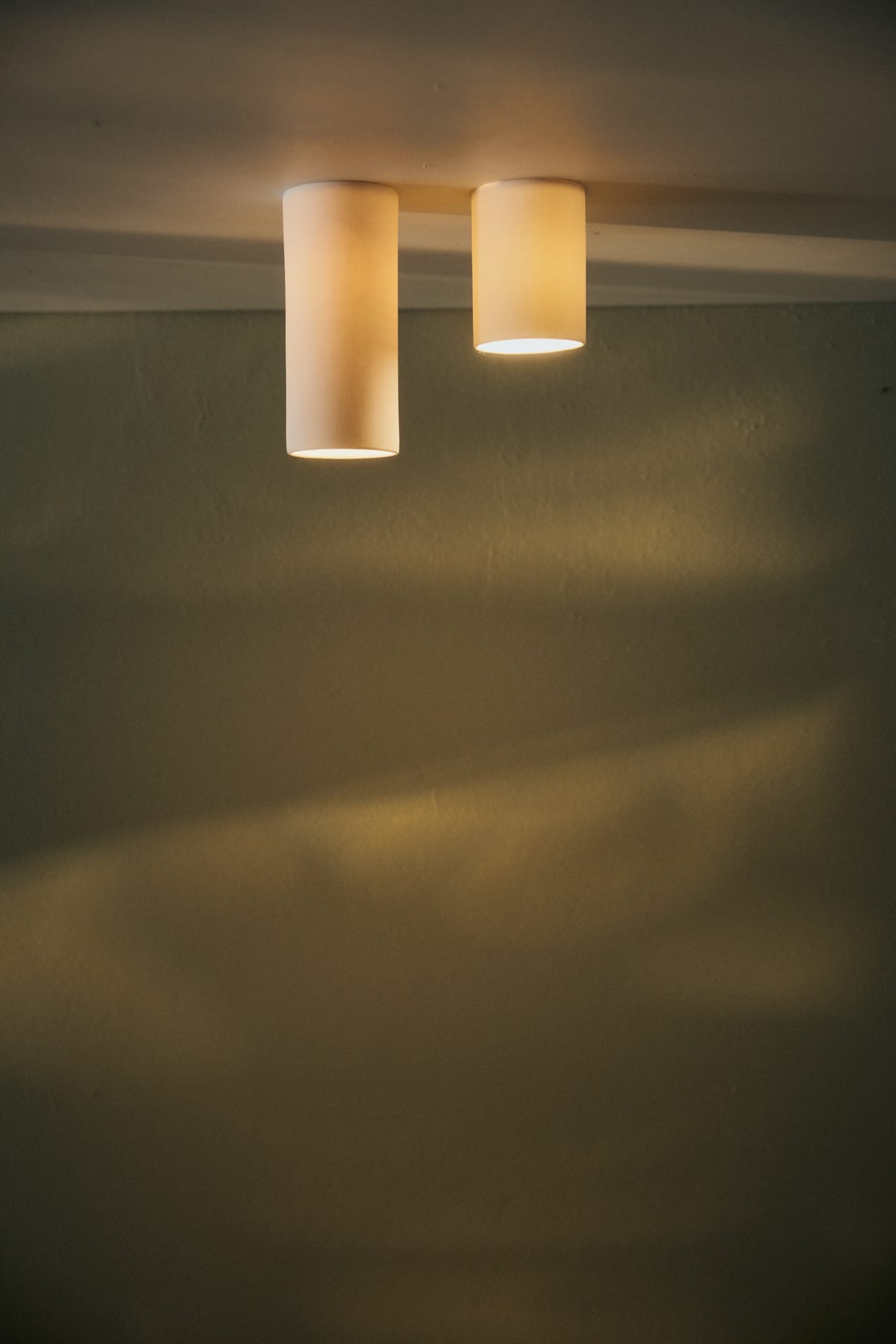 Dusked Ceiling Eos by Studio Enti with a warm yellow glow.