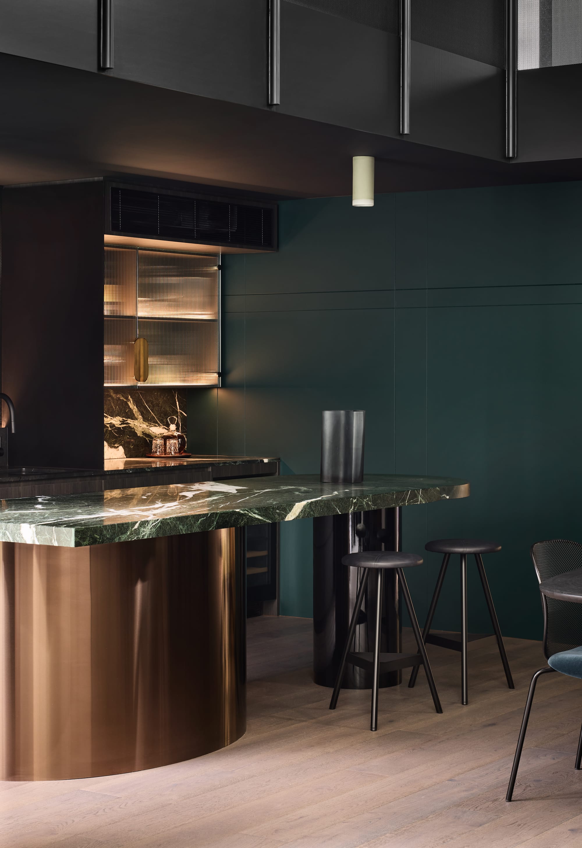 Porcelain Ceiling Eos Light by Studio Enti positioned over a green marble island bench in a well styled kitchen.