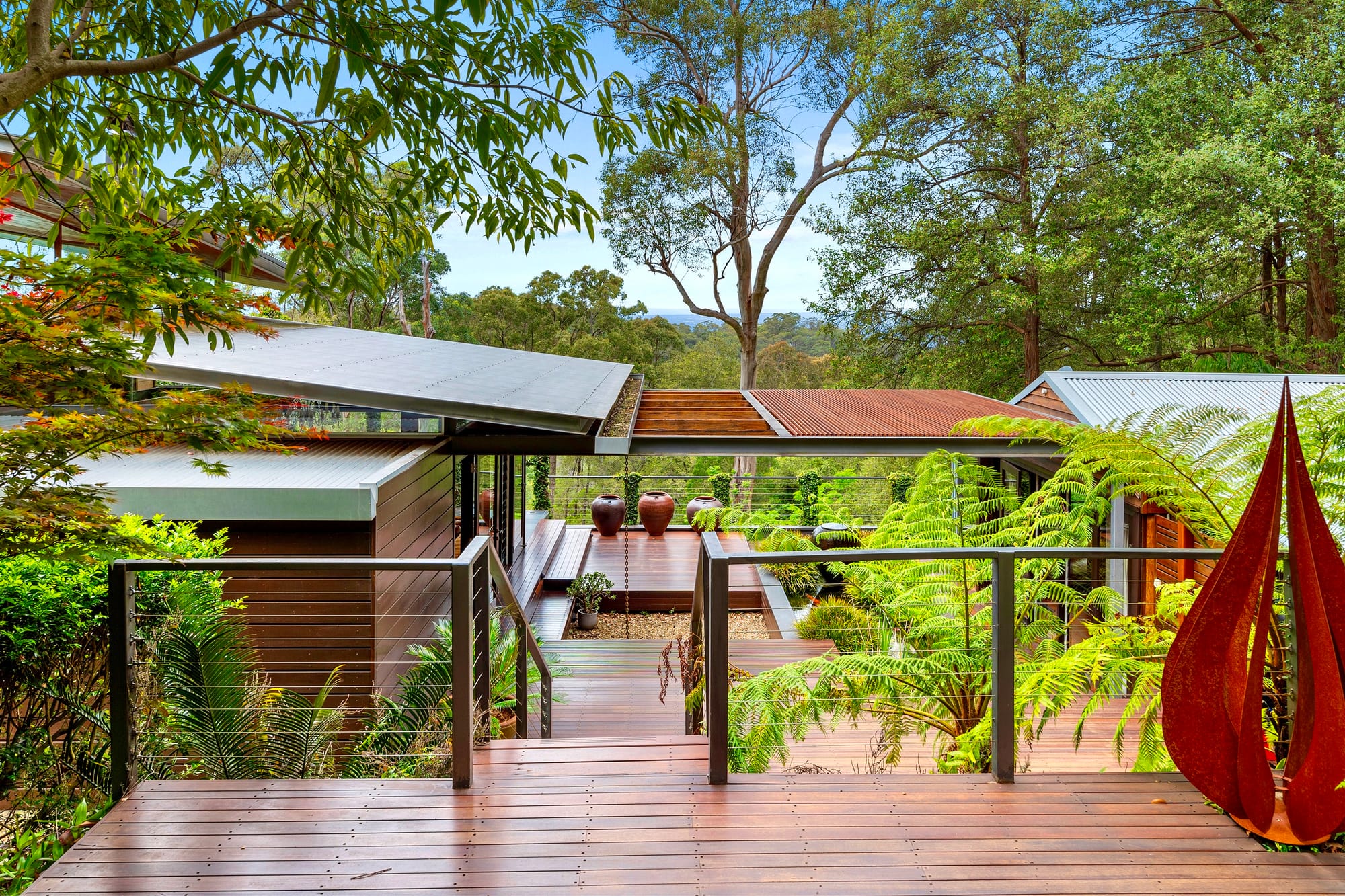 Dadirri Retreat showing the timber deck entry and bushland in the back.